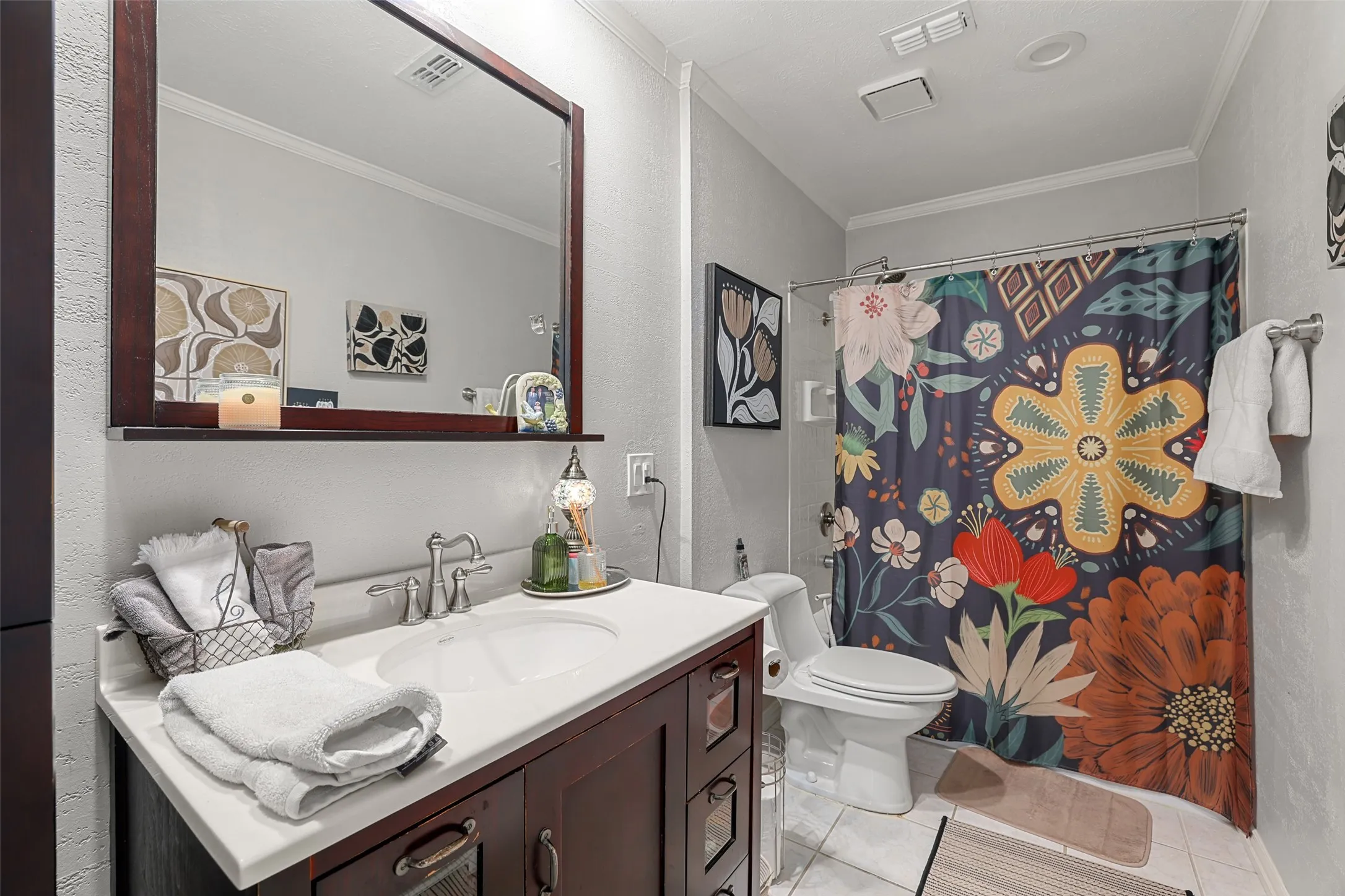Vanity with an integrated sink, polished chrome faucet, and wood-finish cabinetry