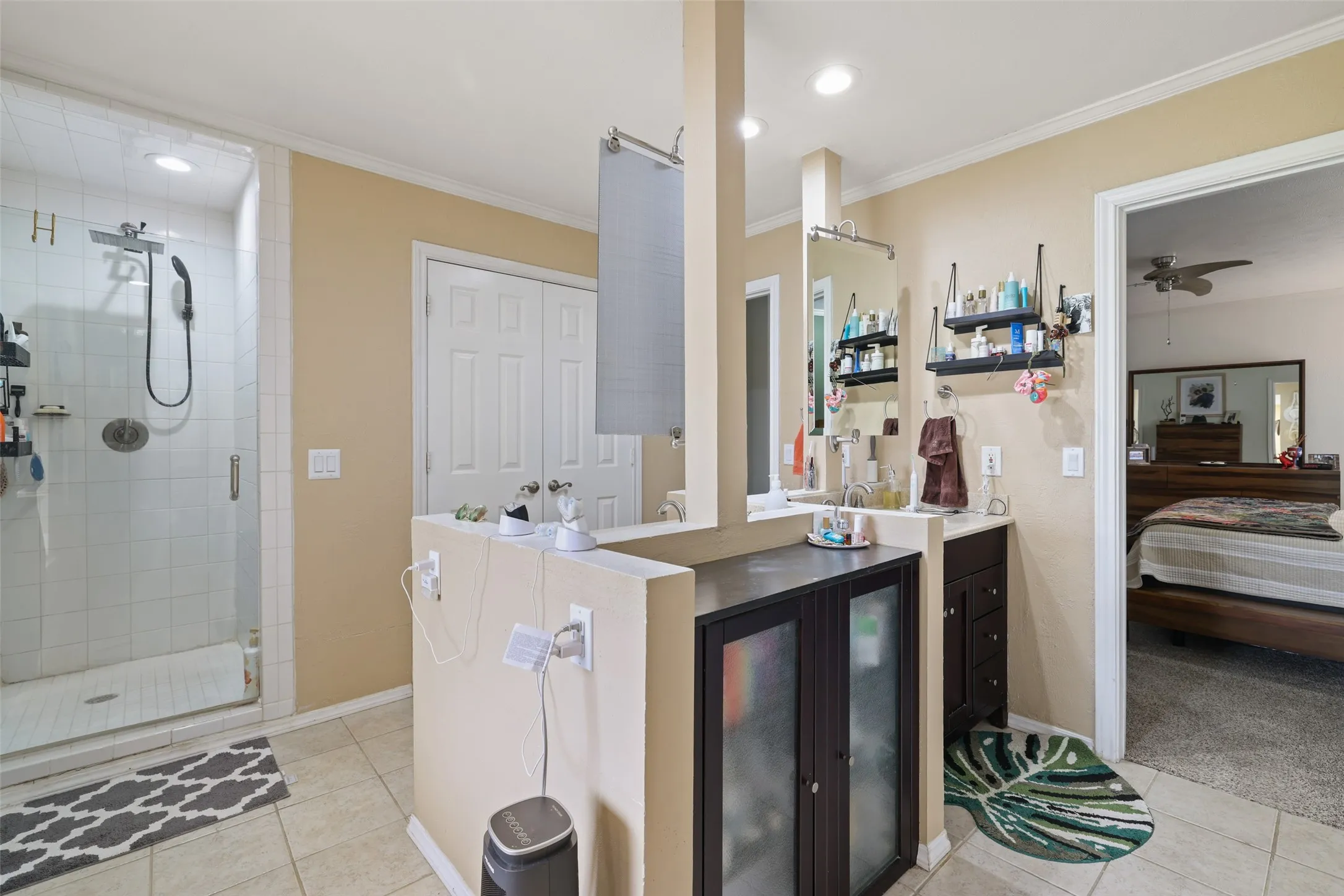 Walk-in shower with tile surround, glass enclosure, and dual shower heads