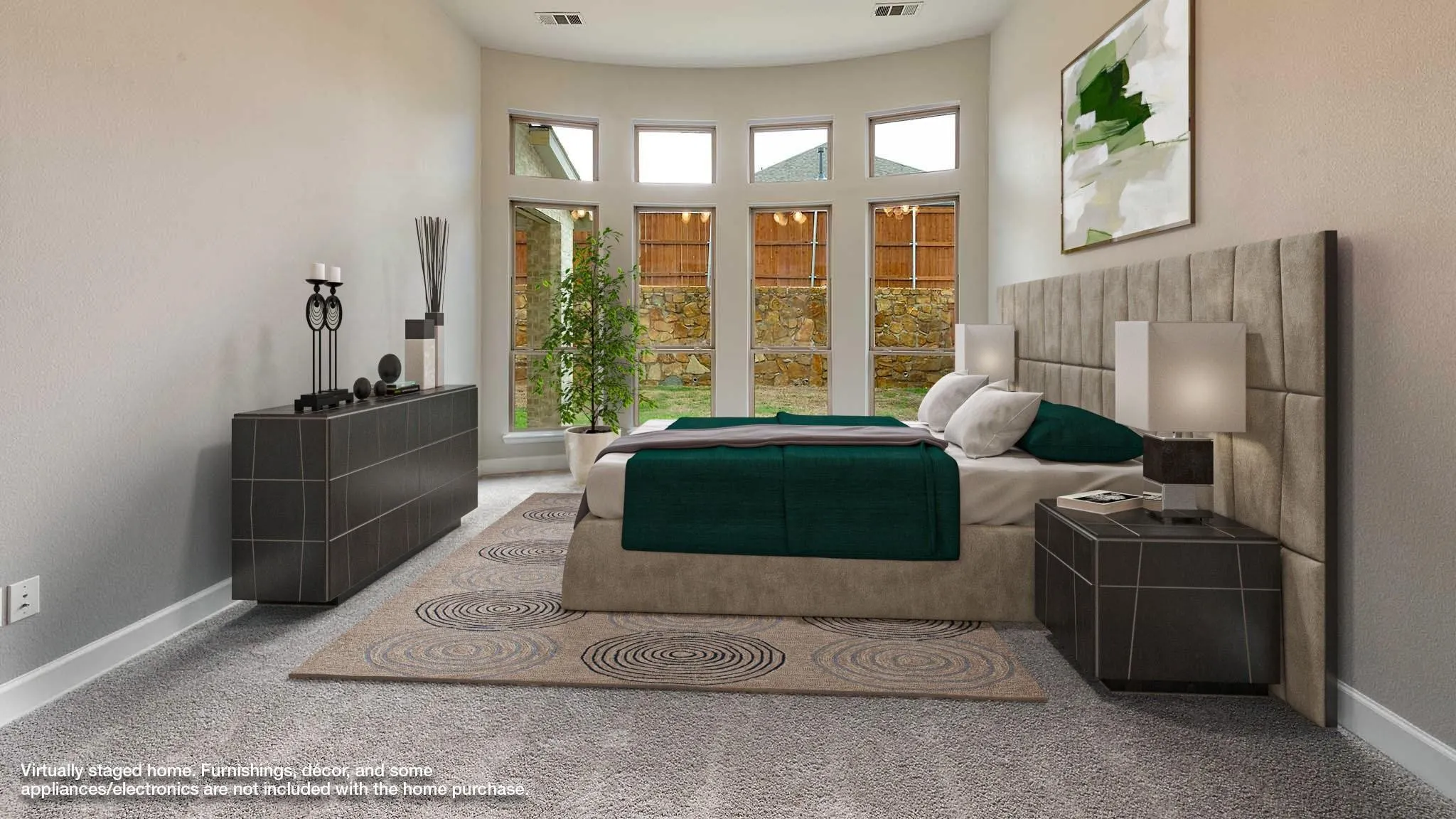 Curved wall with multiple windows, light-toned carpeting, and recessed lighting