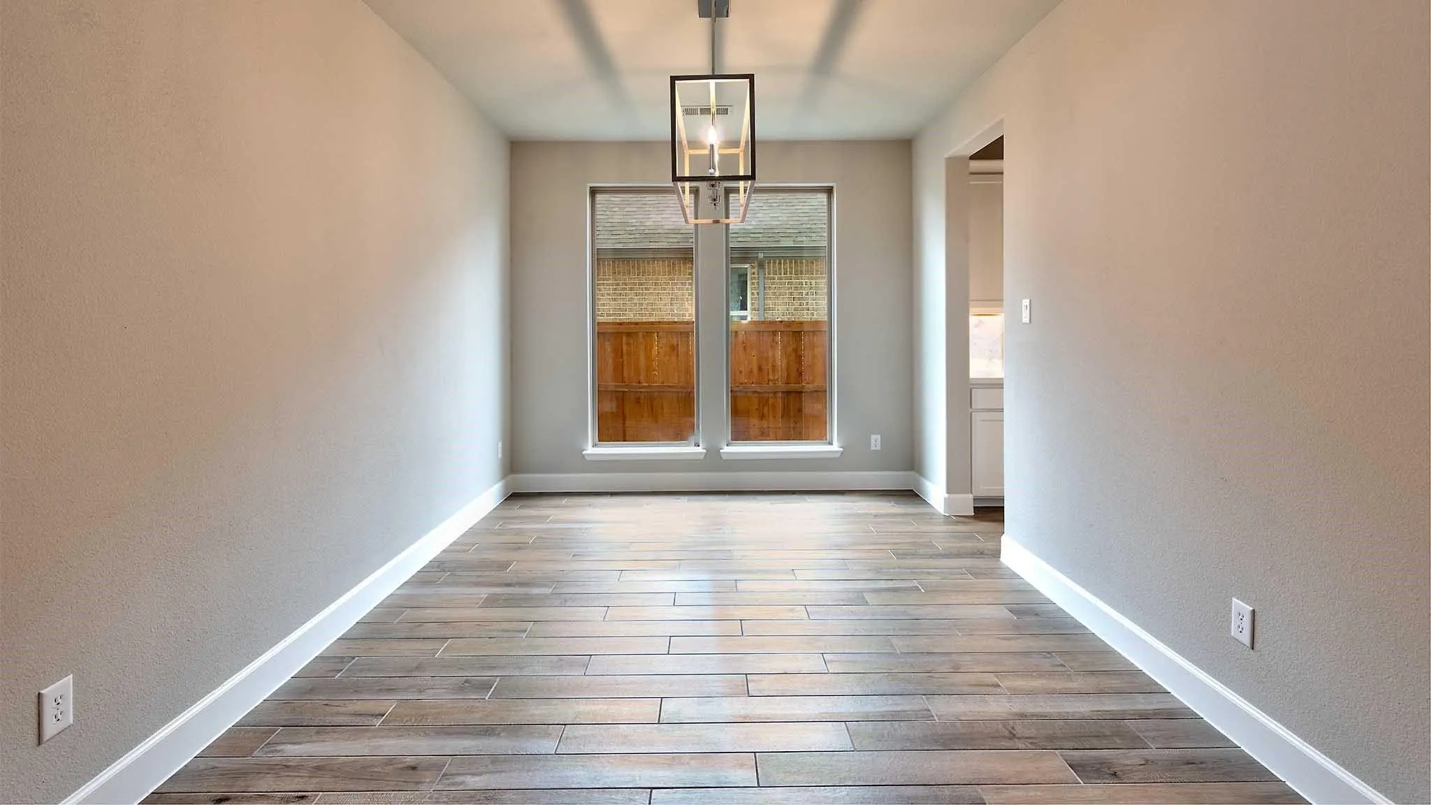 Wood-look plank flooring, neutral wall tones, and recessed lighting