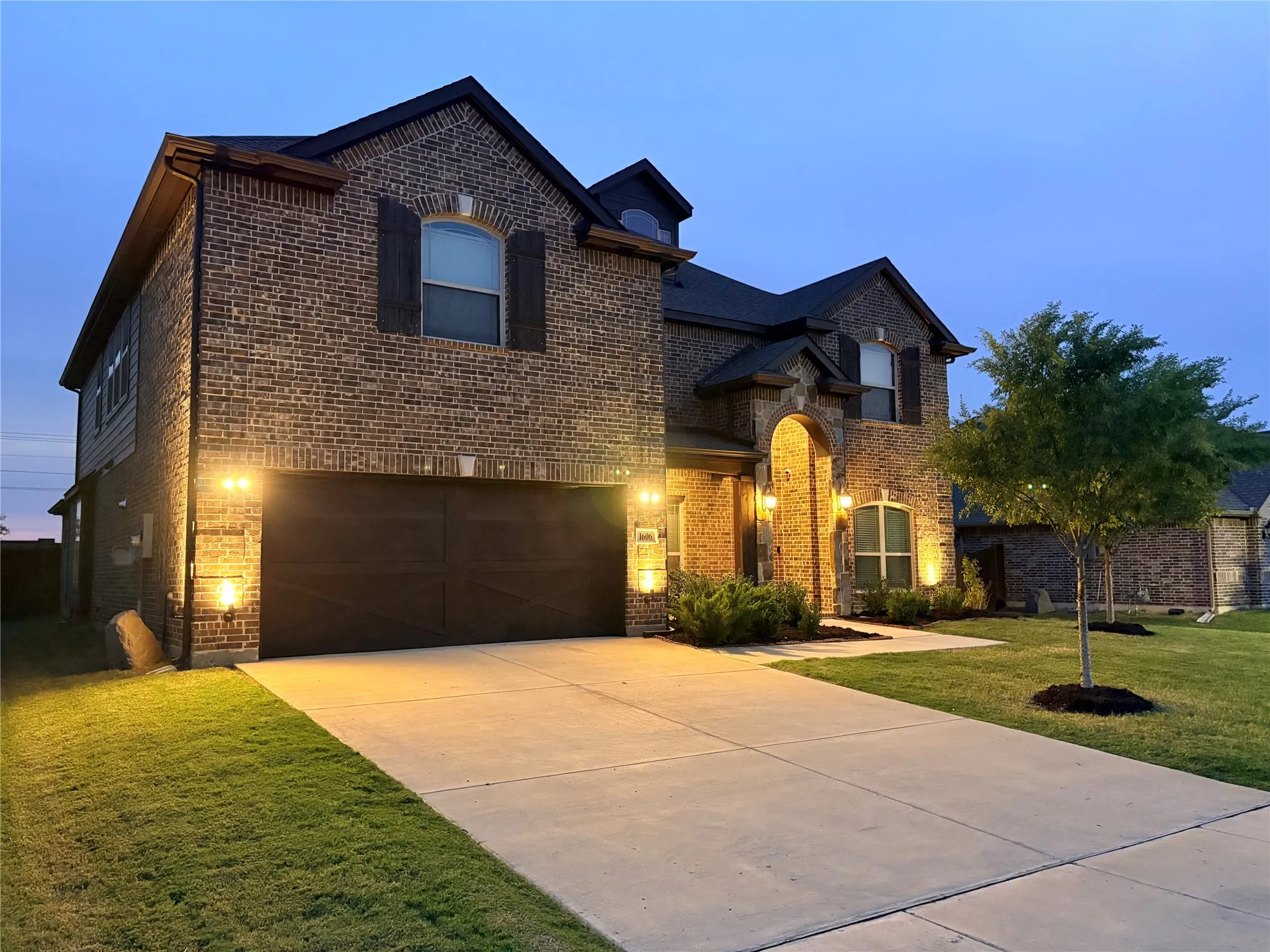Brick exterior with dark trim and arched entry