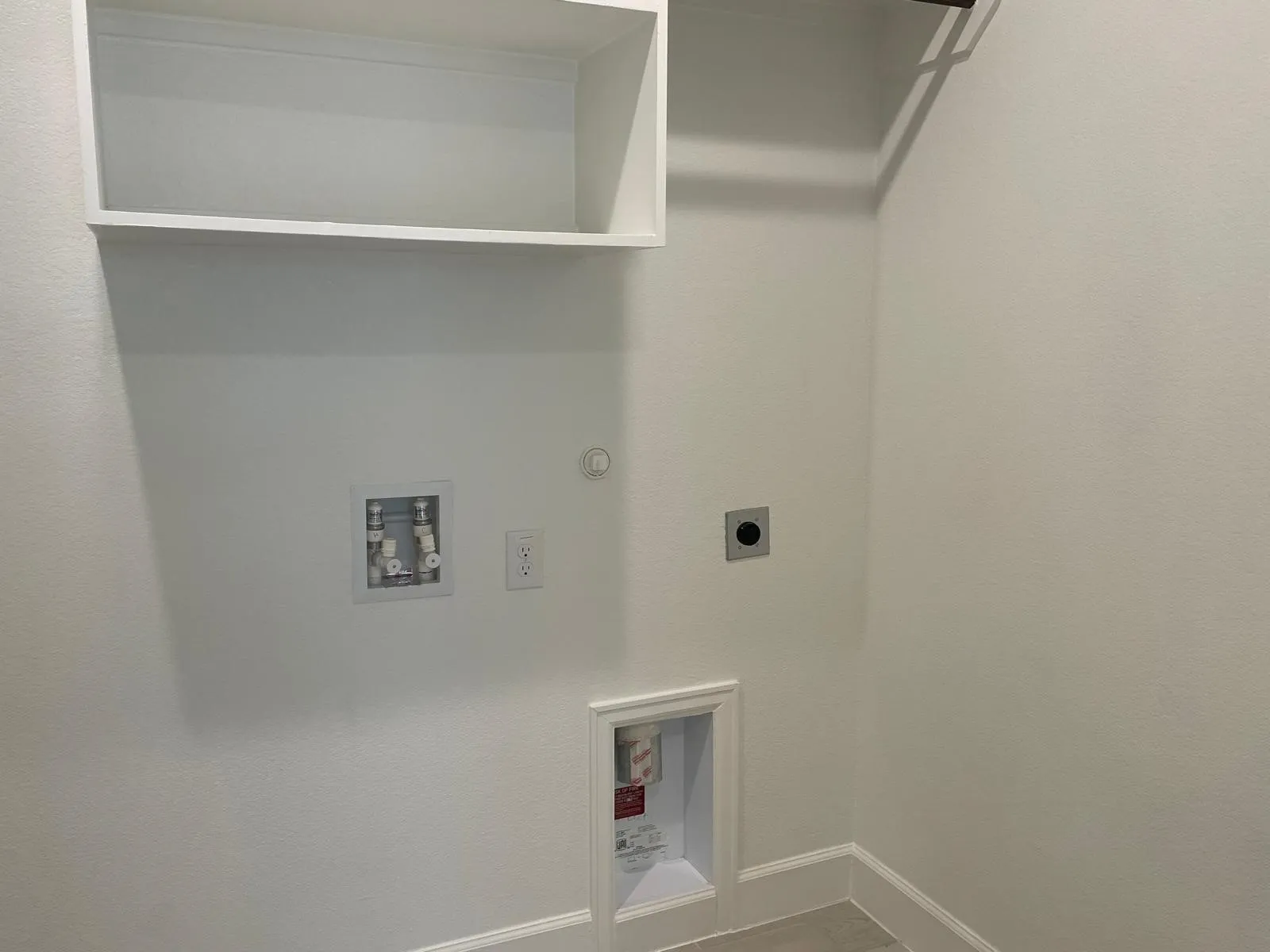 Clothes washing area with hookup for a gas dryer, electric dryer hookup, and washer hookup