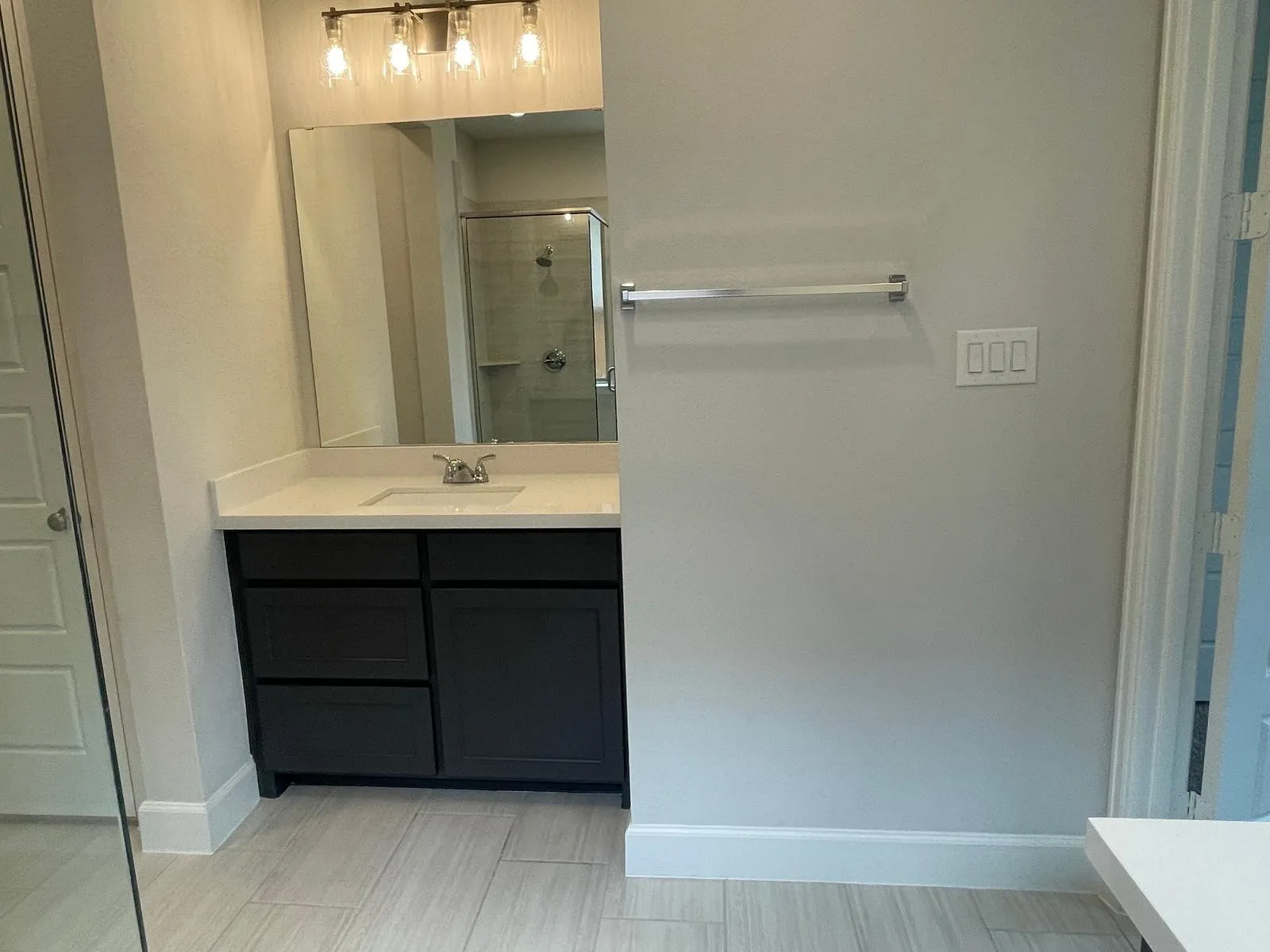 Bathroom featuring vanity and a shower with shower door