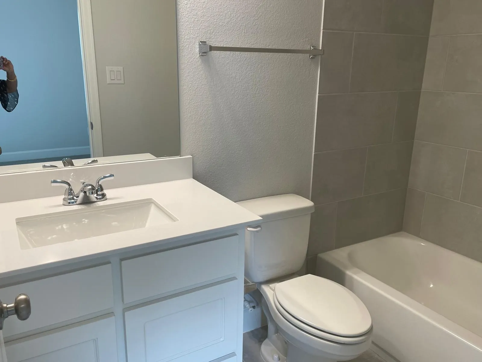 Full bathroom featuring vanity, toilet, and tiled shower / bath combo
