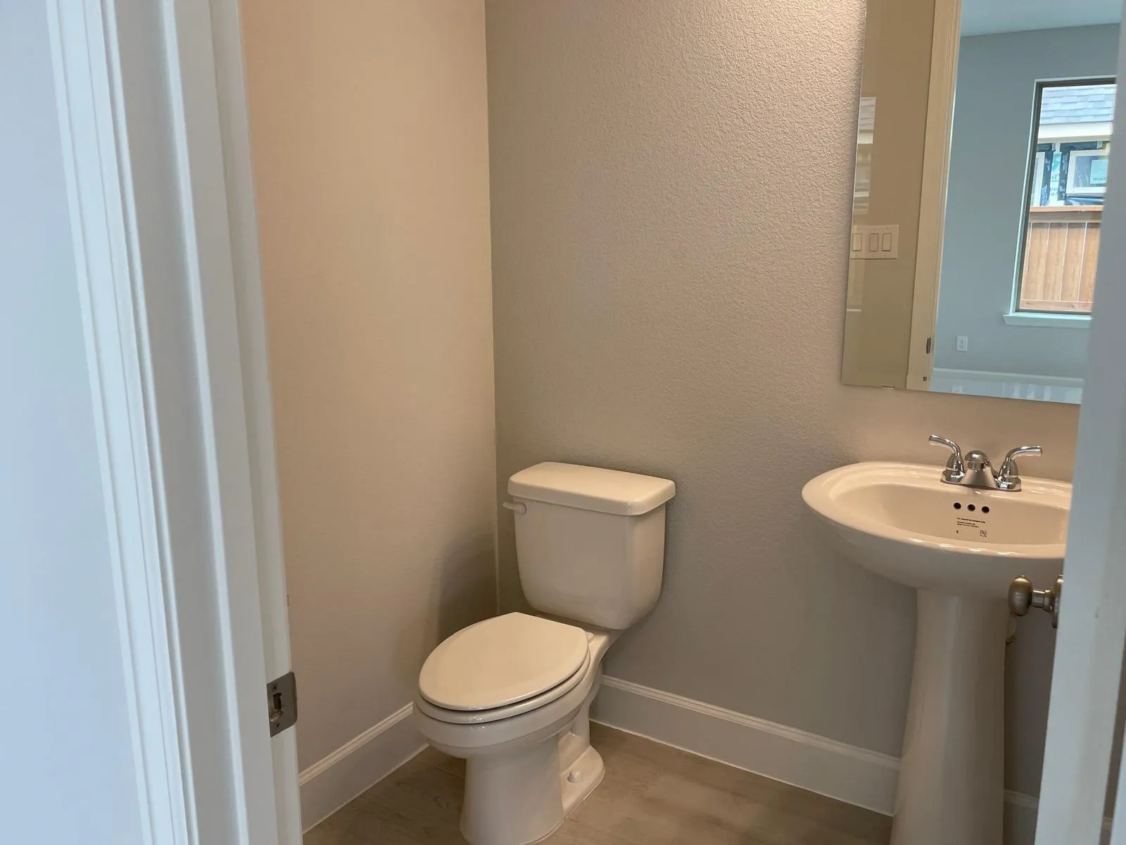 Bathroom featuring hardwood / wood-style floors and toilet