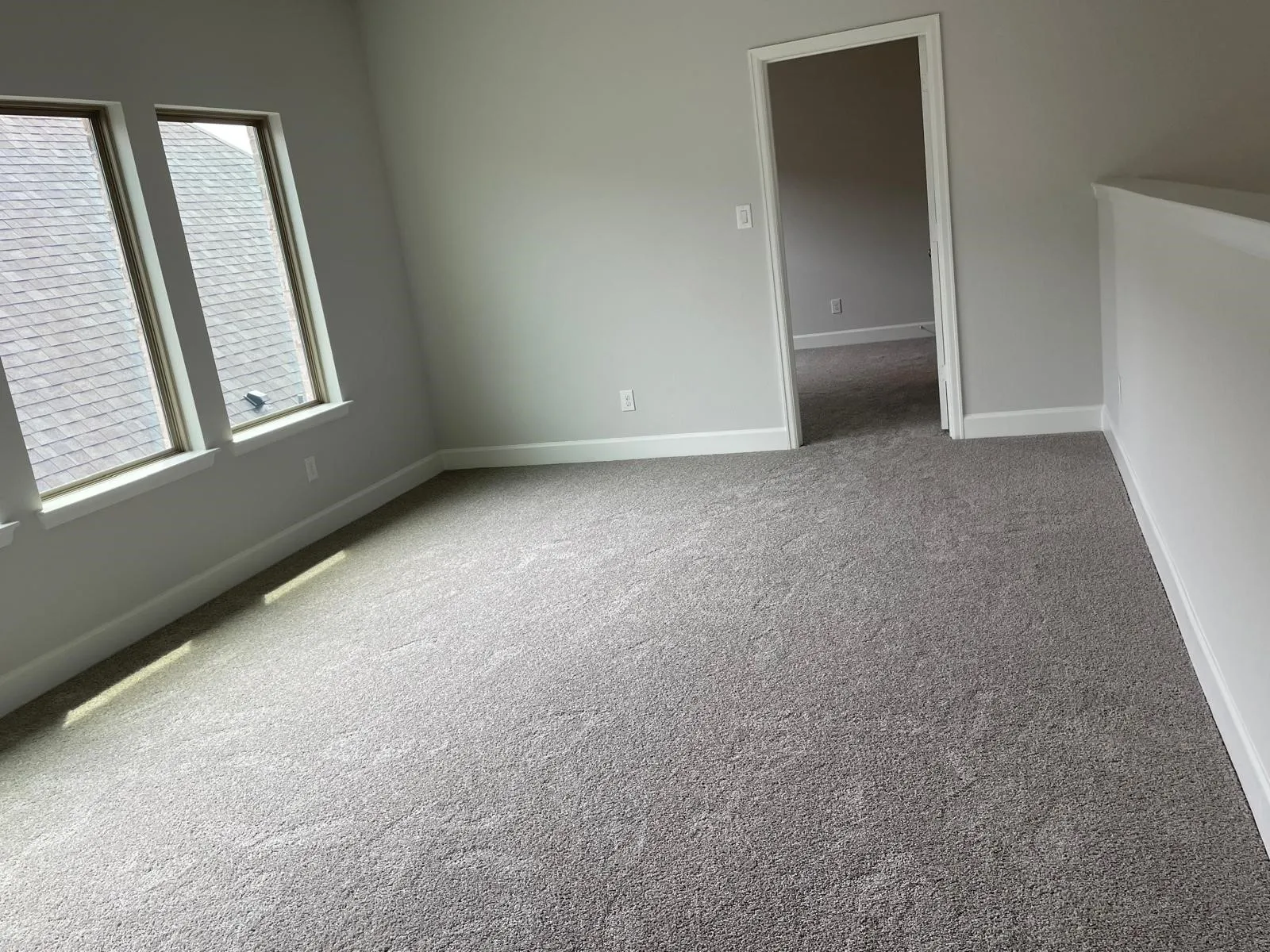 Carpeted empty room with a healthy amount of sunlight