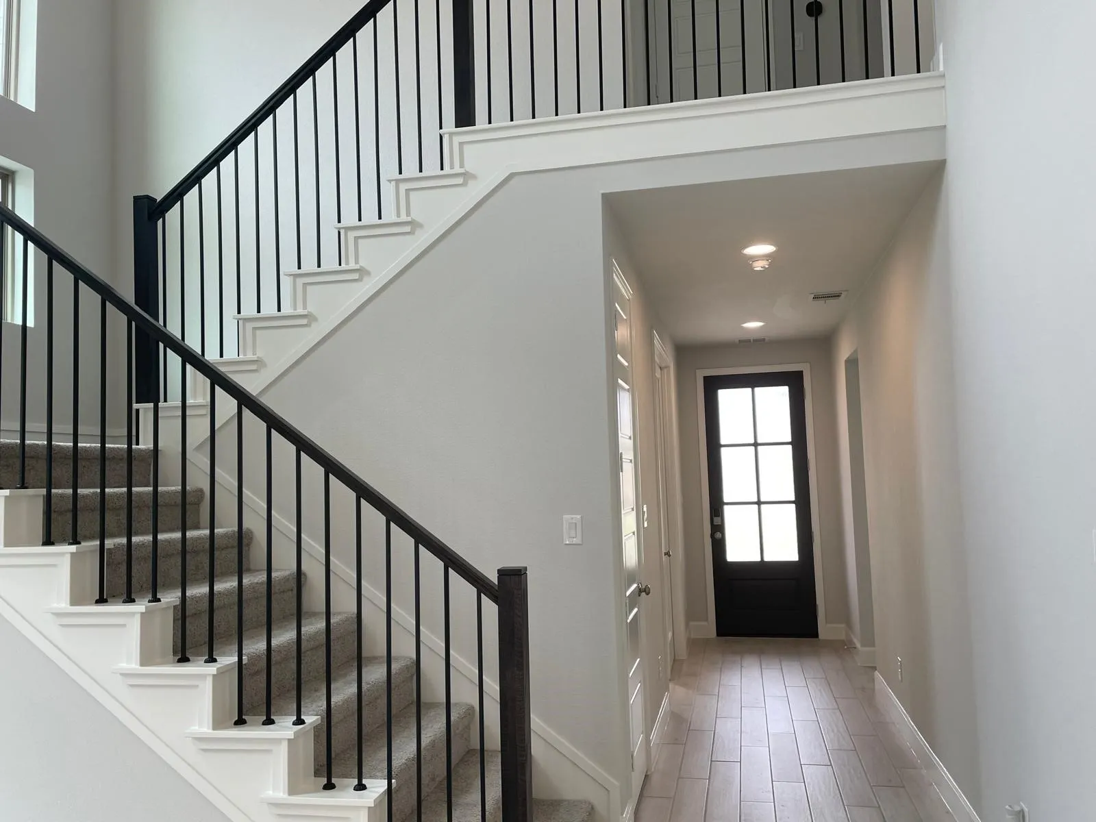 Foyer entrance featuring hardwood / wood-style flooring and a high ceiling