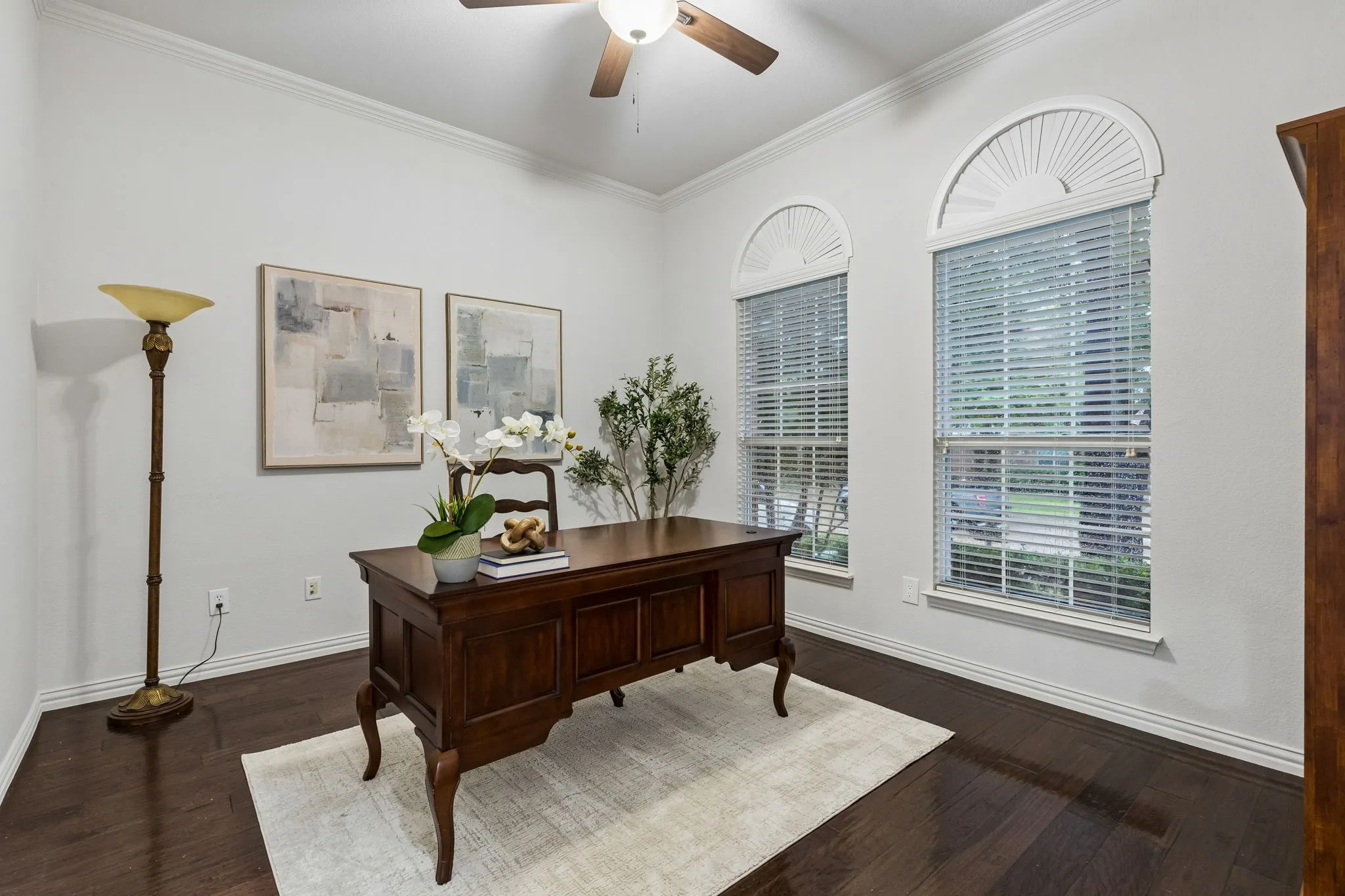 Dark wood-finish flooring with white baseboards