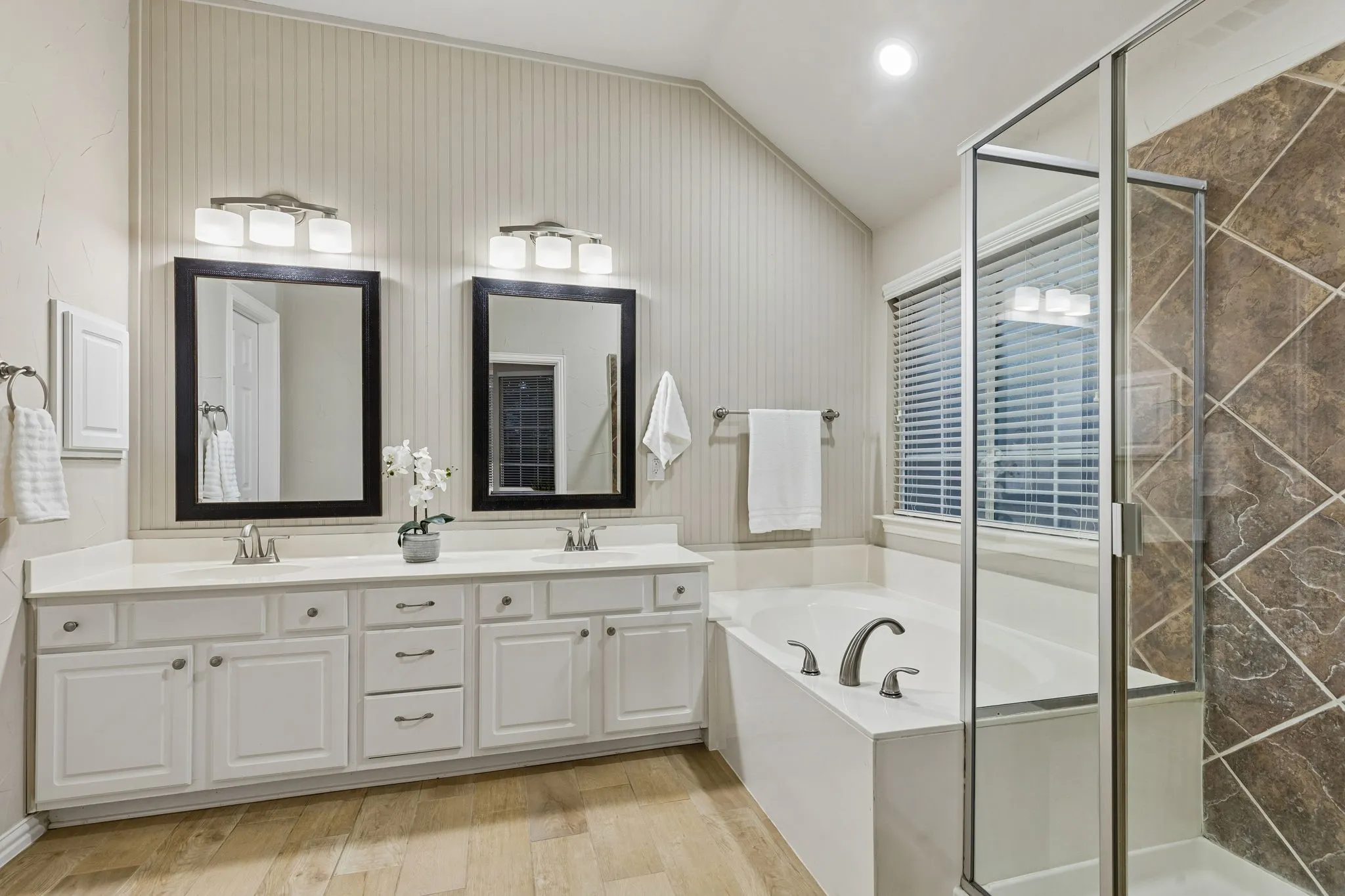 Dual vanity with undermount sinks, white cabinetry, and a light-toned countertop