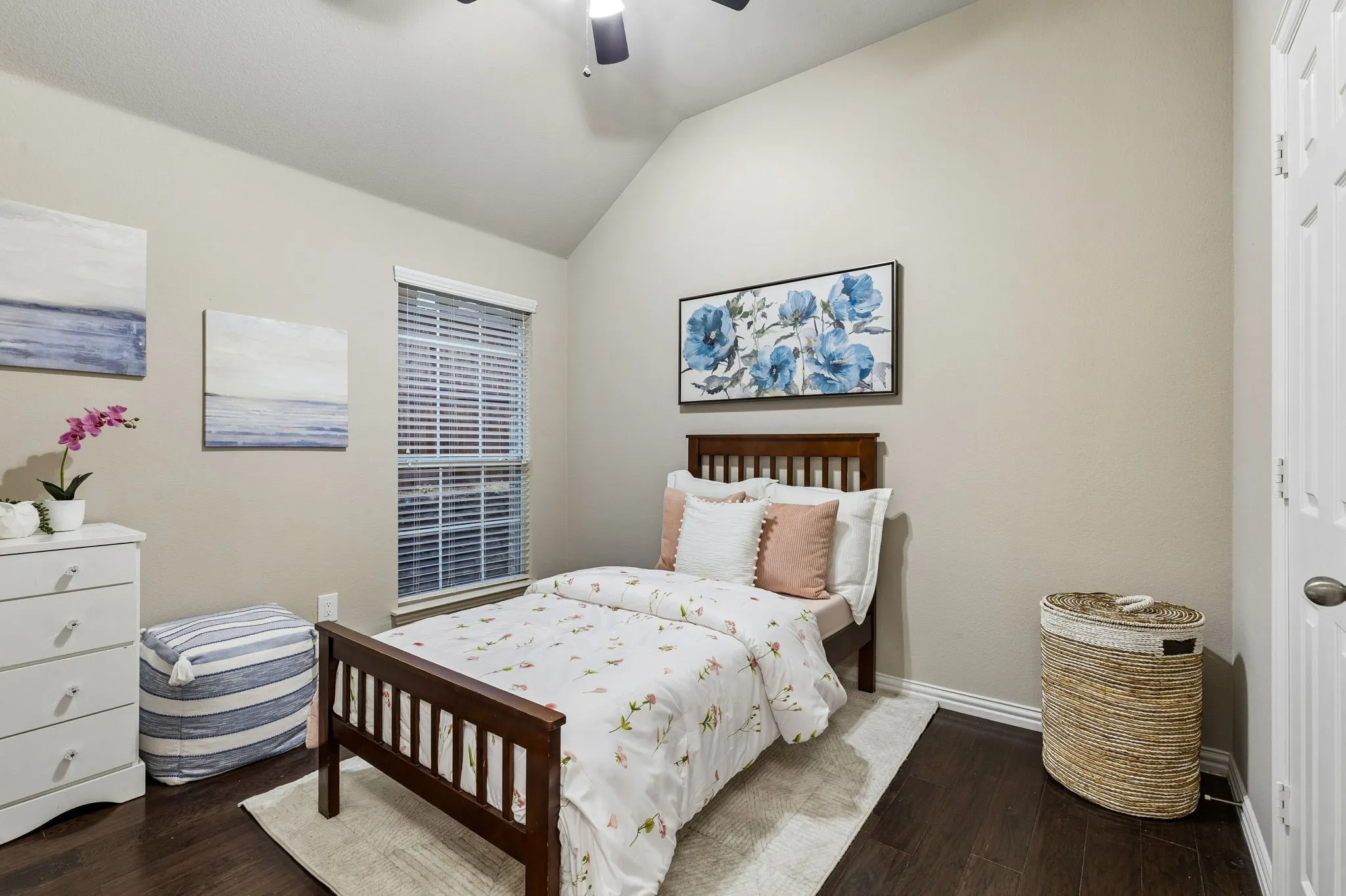 Vaulted ceiling, wood-finish flooring, ceiling fan, window with blinds, and white door with decorative paneling
