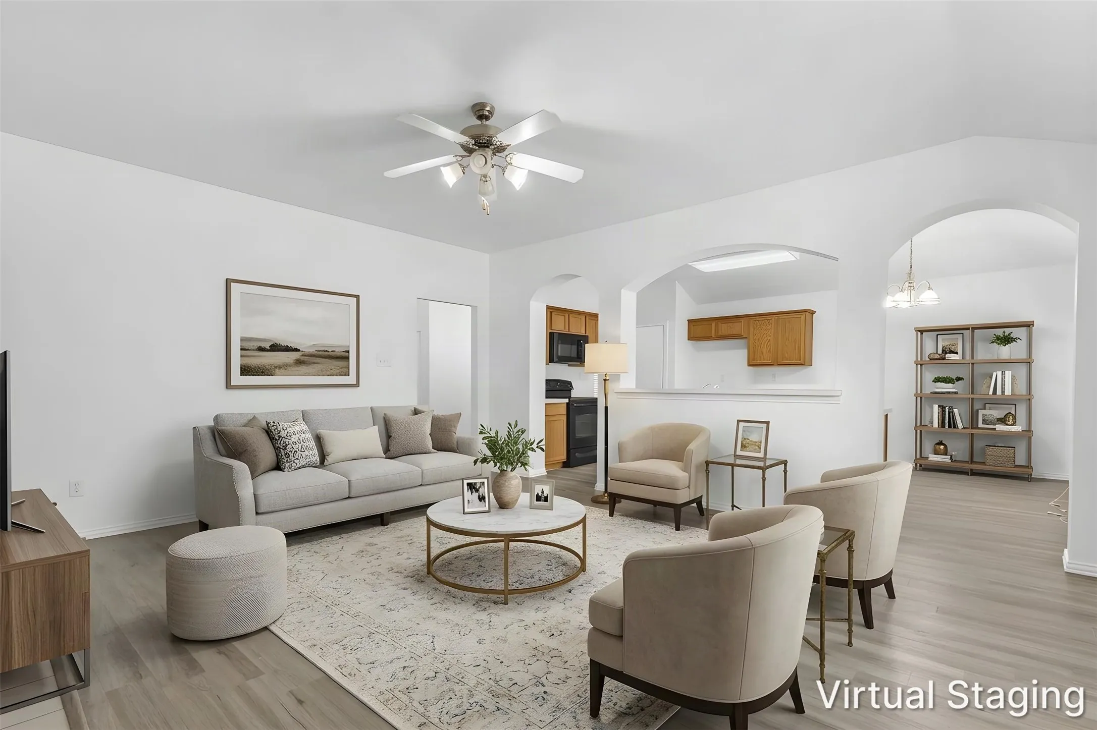 Virtually staged living room open to the kitchen and breakfast area through arched openings