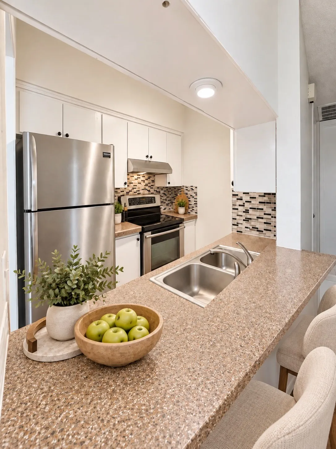Virtually staged. Kitchen from the breakfast bar.