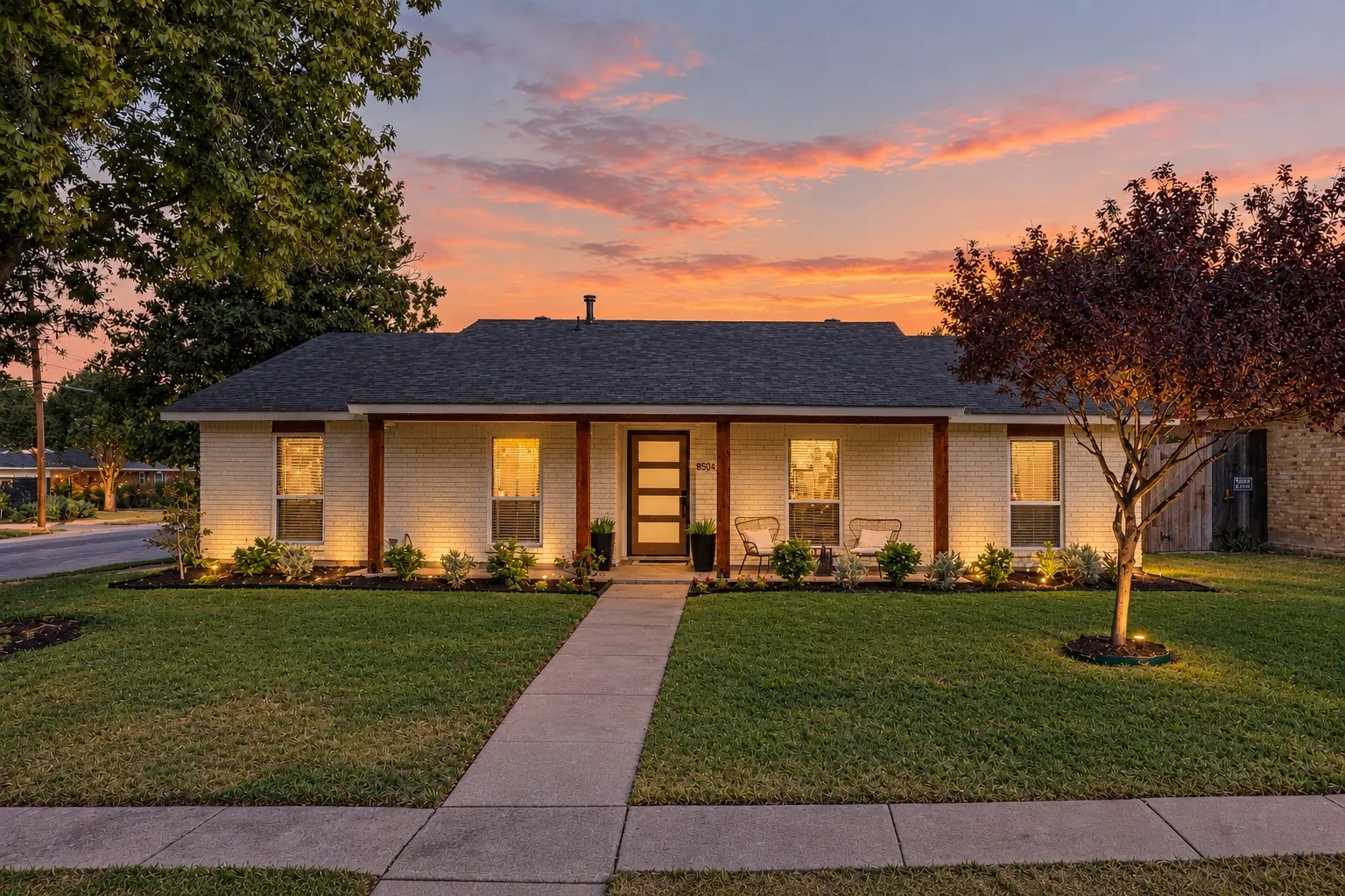 White brick exterior with dark trim windows