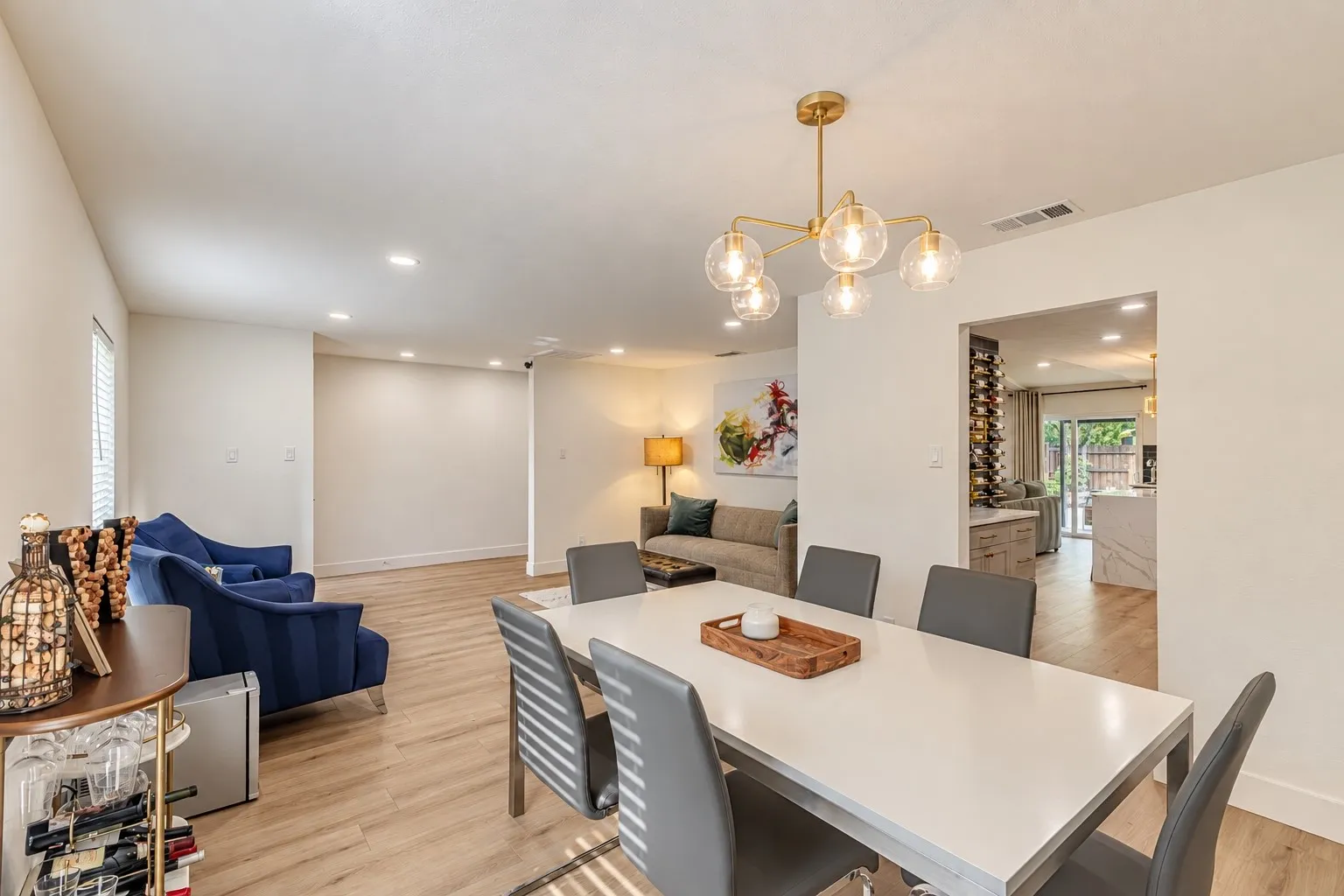 Dining area featuring wood-finish flooring, a contemporary chandelier, and recessed lighting