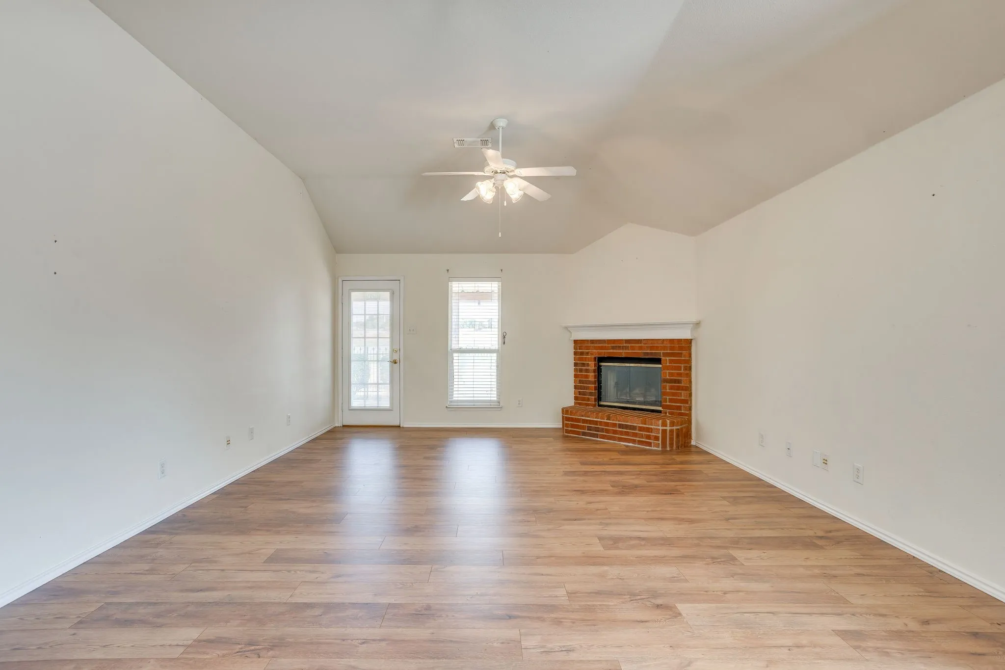 17x15 Living Room with Brick woodburning FP with wood mantle and raised hearth
