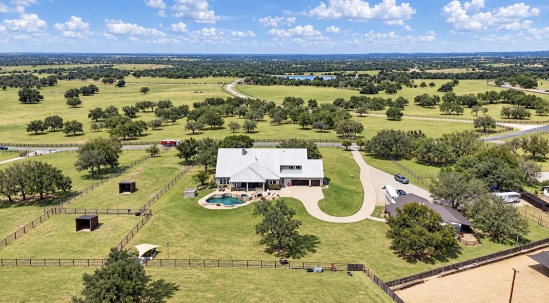 Single-family residence with a metal roof and an in-ground swimming pool