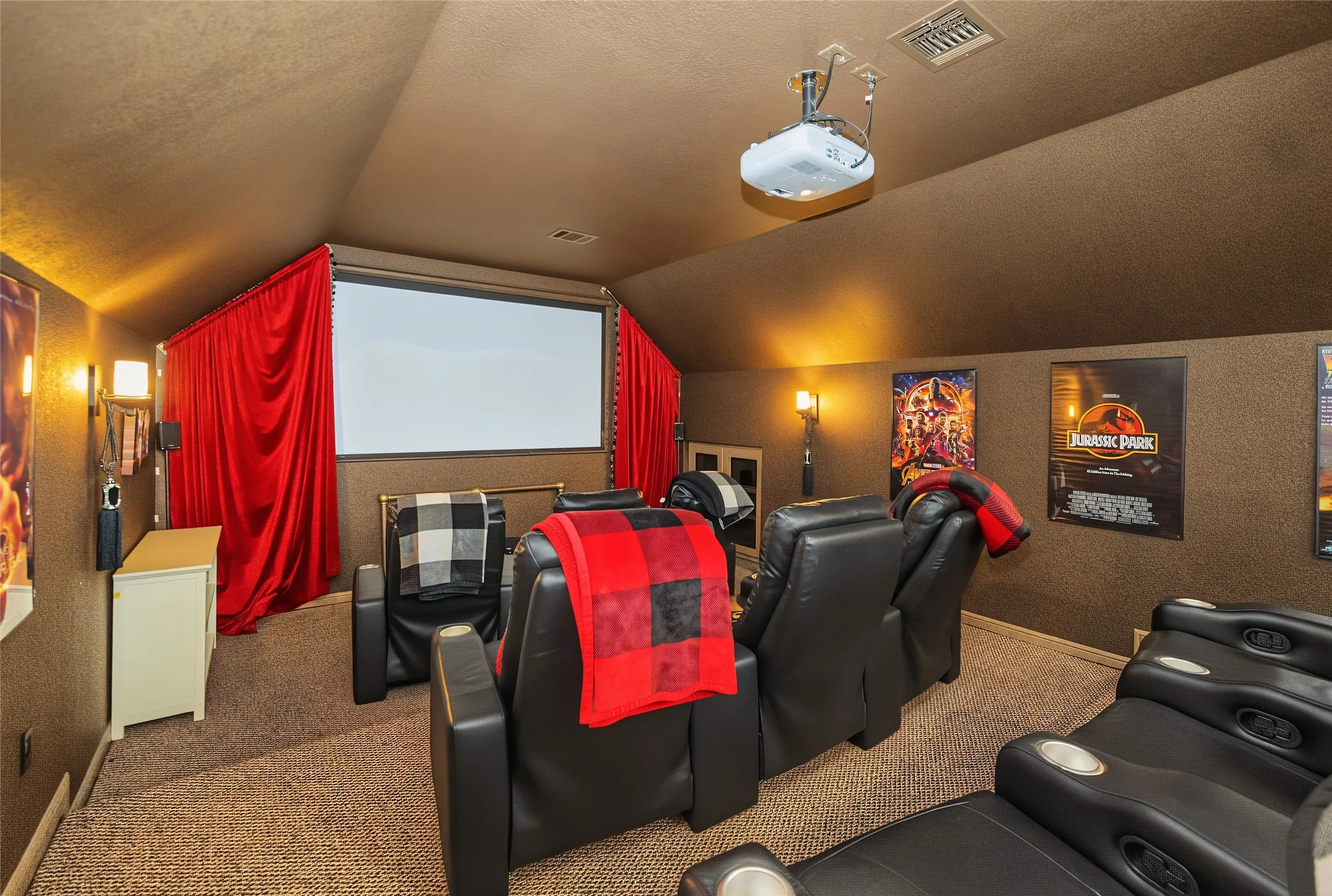Dedicated media room with a projector, screen, and recessed lighting