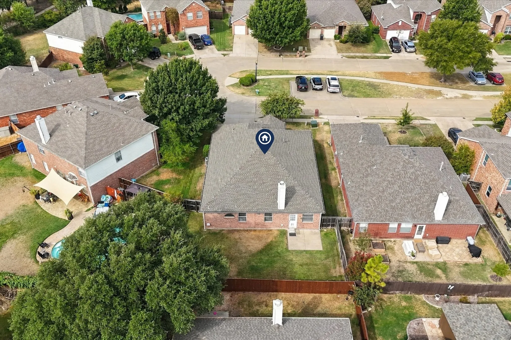 Aerial view highlights the home's cul-de-sac location and additional parking along the street.