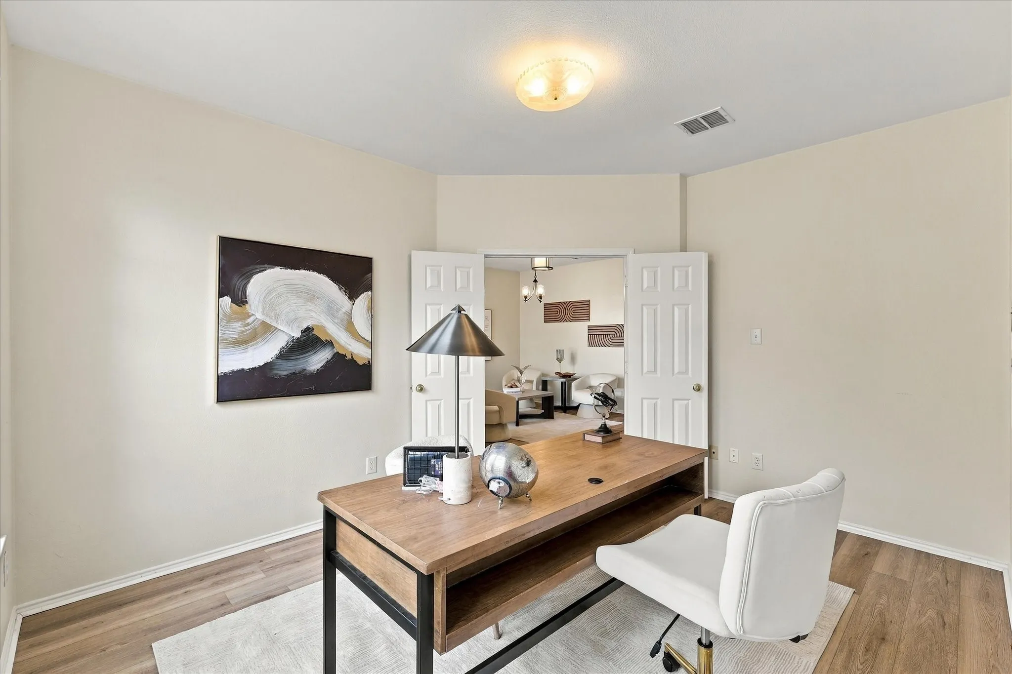 French doors open to a dedicated home office, offering a comfortable, private space to work from home, tackle homework or simply keep life organized.