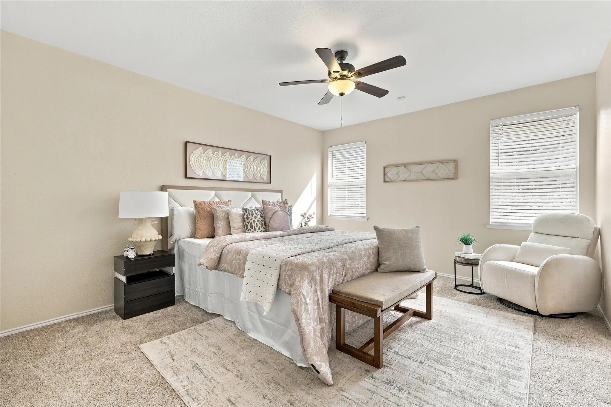 The spacious primary bedroom offers a comfortable retreat with a ceiling fan and a generous walk-in closet with plenty of room to stay organized.