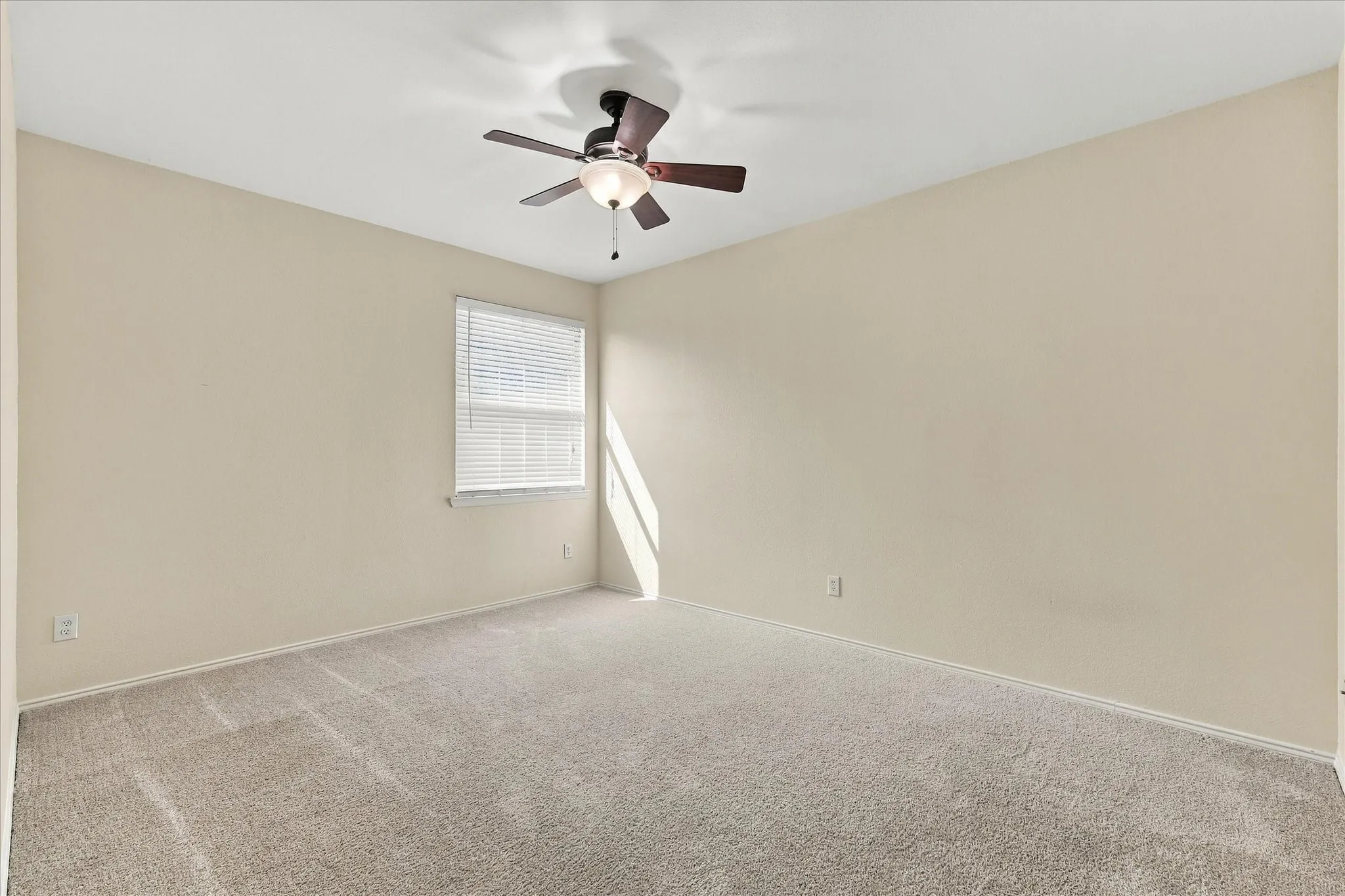 Shown here without staging, this spacious secondary bedroom gives you a true sense of the room’s size, space and flexibility.