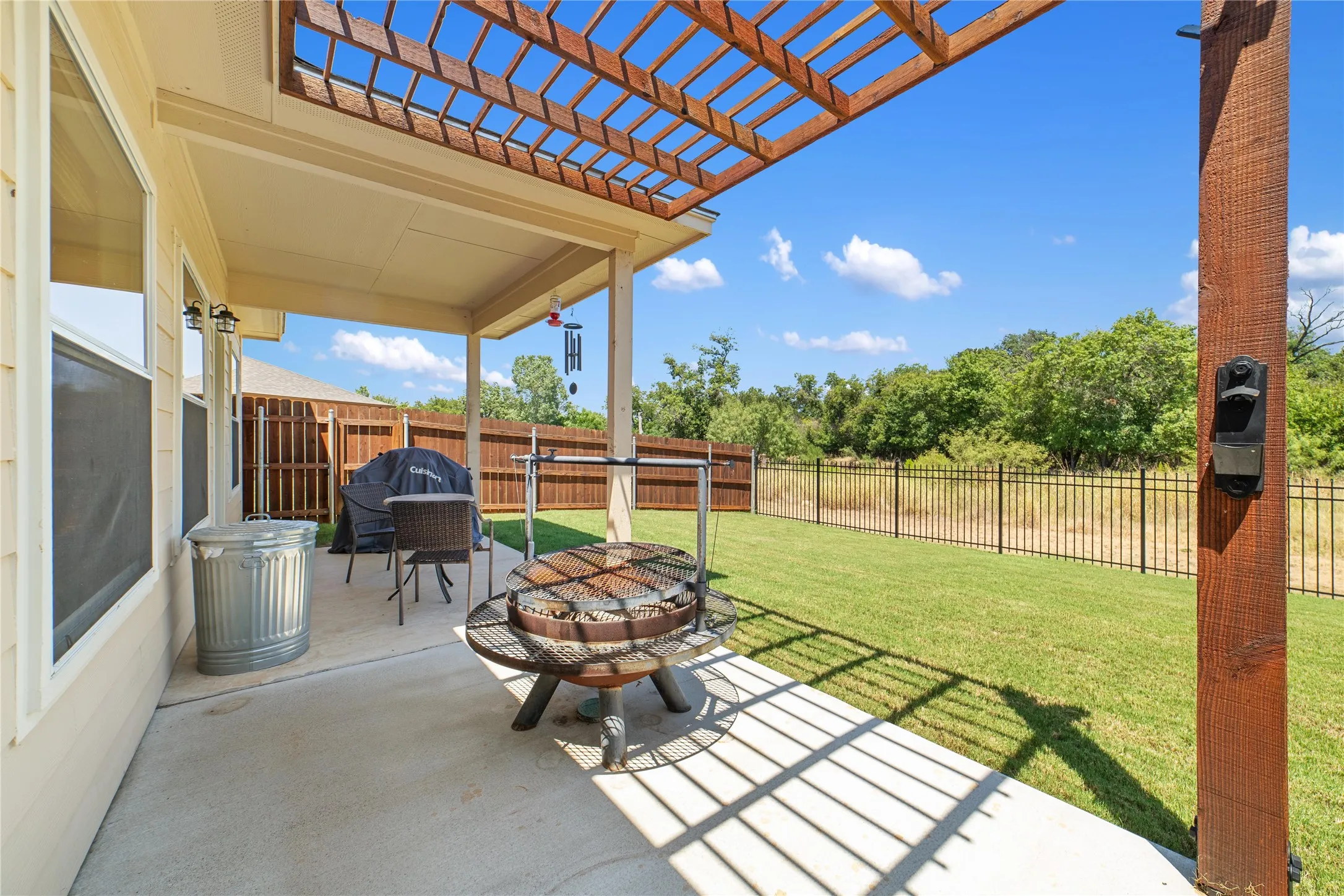 View of patio featuring a pergola, an outdoor fire pit, and a grill