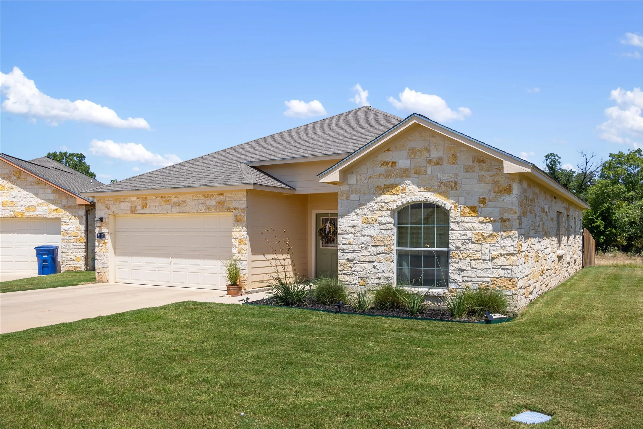View of front of home with a front yard and a garage