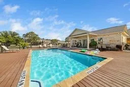 View of swimming pool with a deck