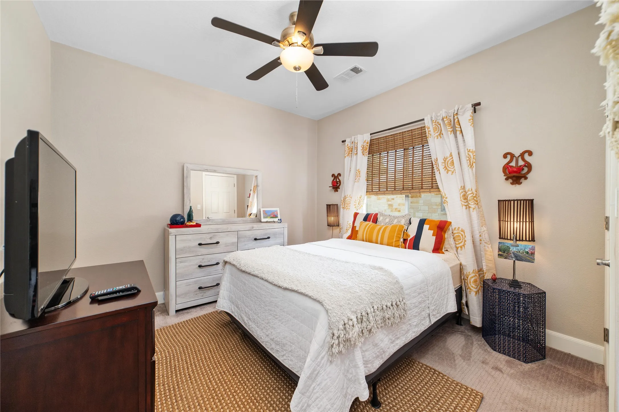 Bedroom featuring light carpet and ceiling fan