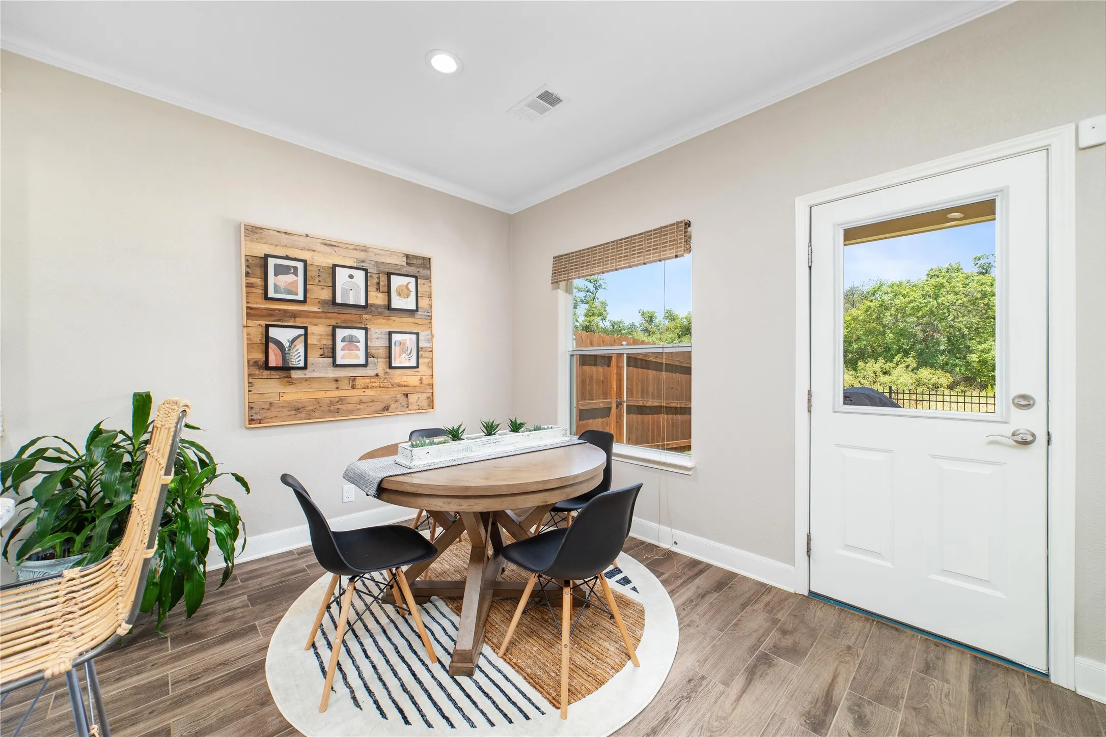 Dining room with crown molding and wood-type flooring