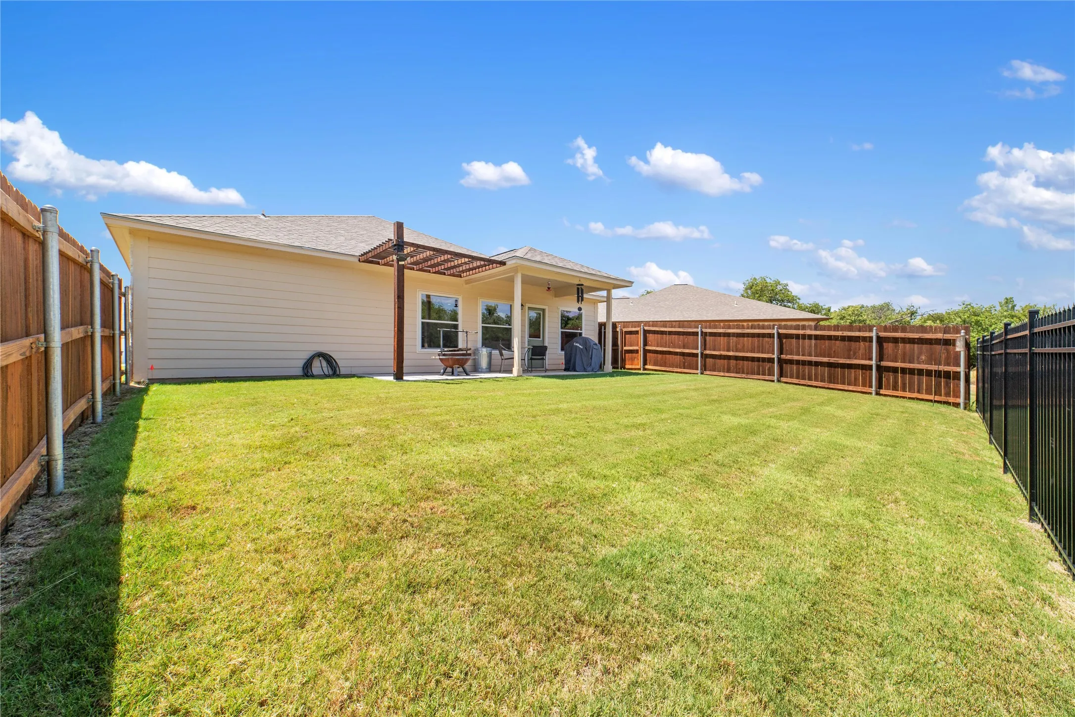 Back of property featuring a patio and a lawn