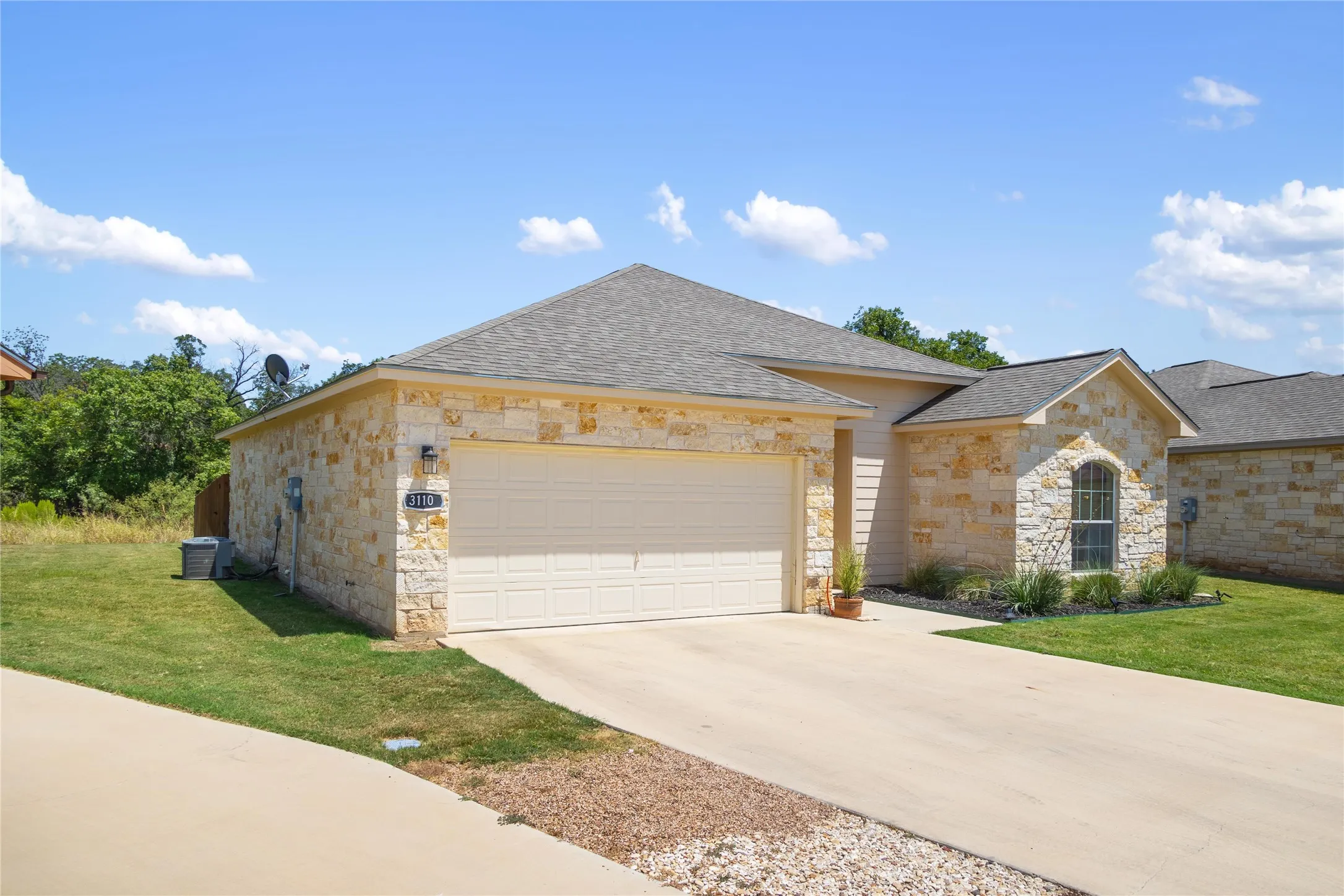 View of front of house featuring a front lawn and a garage