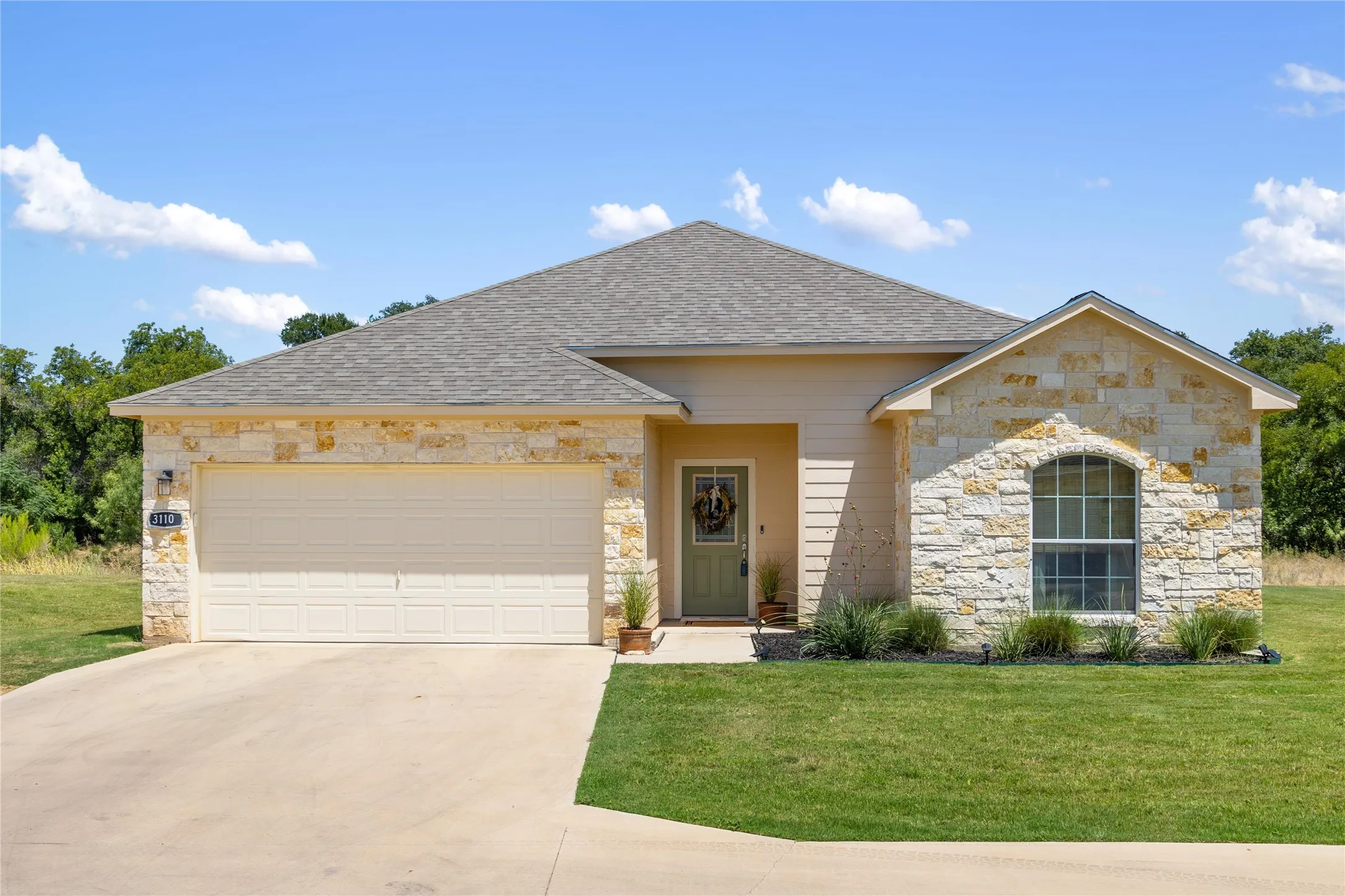 View of front of house with a front lawn and a garage