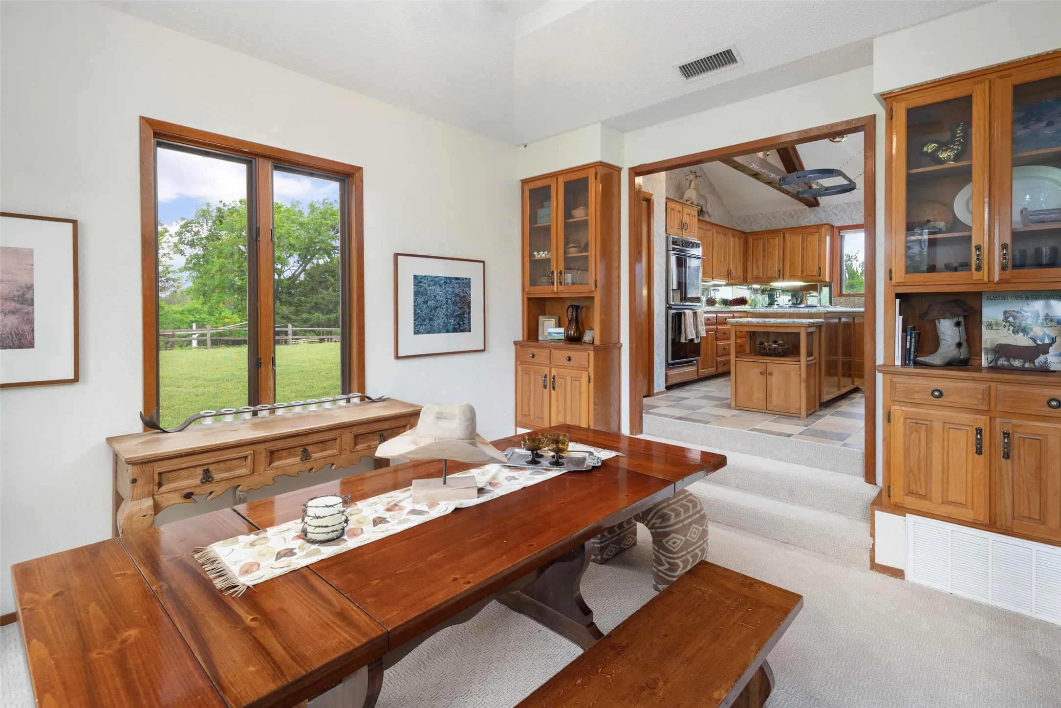 Dining area featuring a wood-finish dining table with matching benches