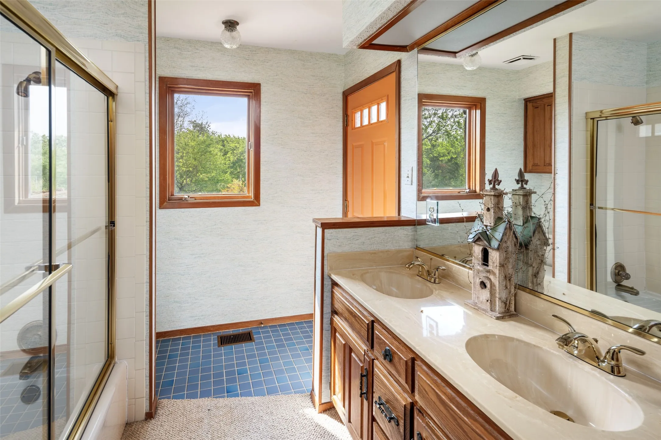 Dual vanity with integrated sinks, framed mirror, and wood-finish cabinetry