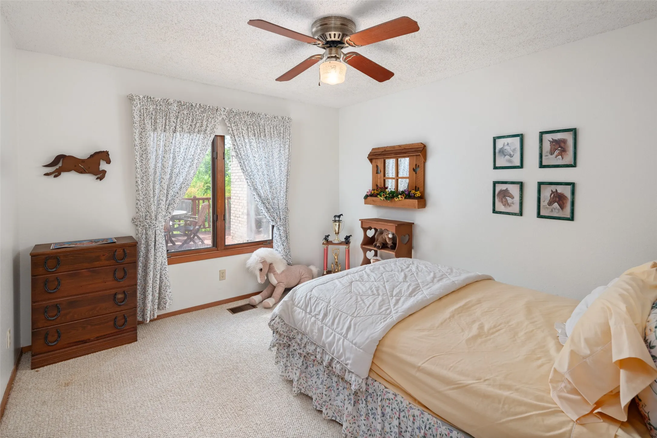 Carpeted flooring, single window, and a ceiling fan with light fixture