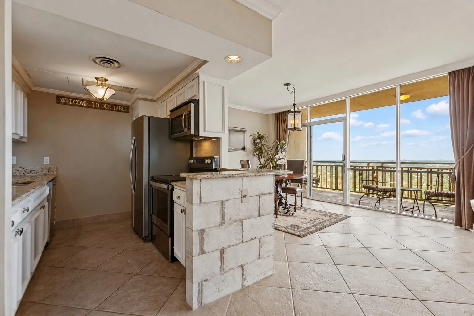 Kitchen opens to dining area and has a breakfast bar