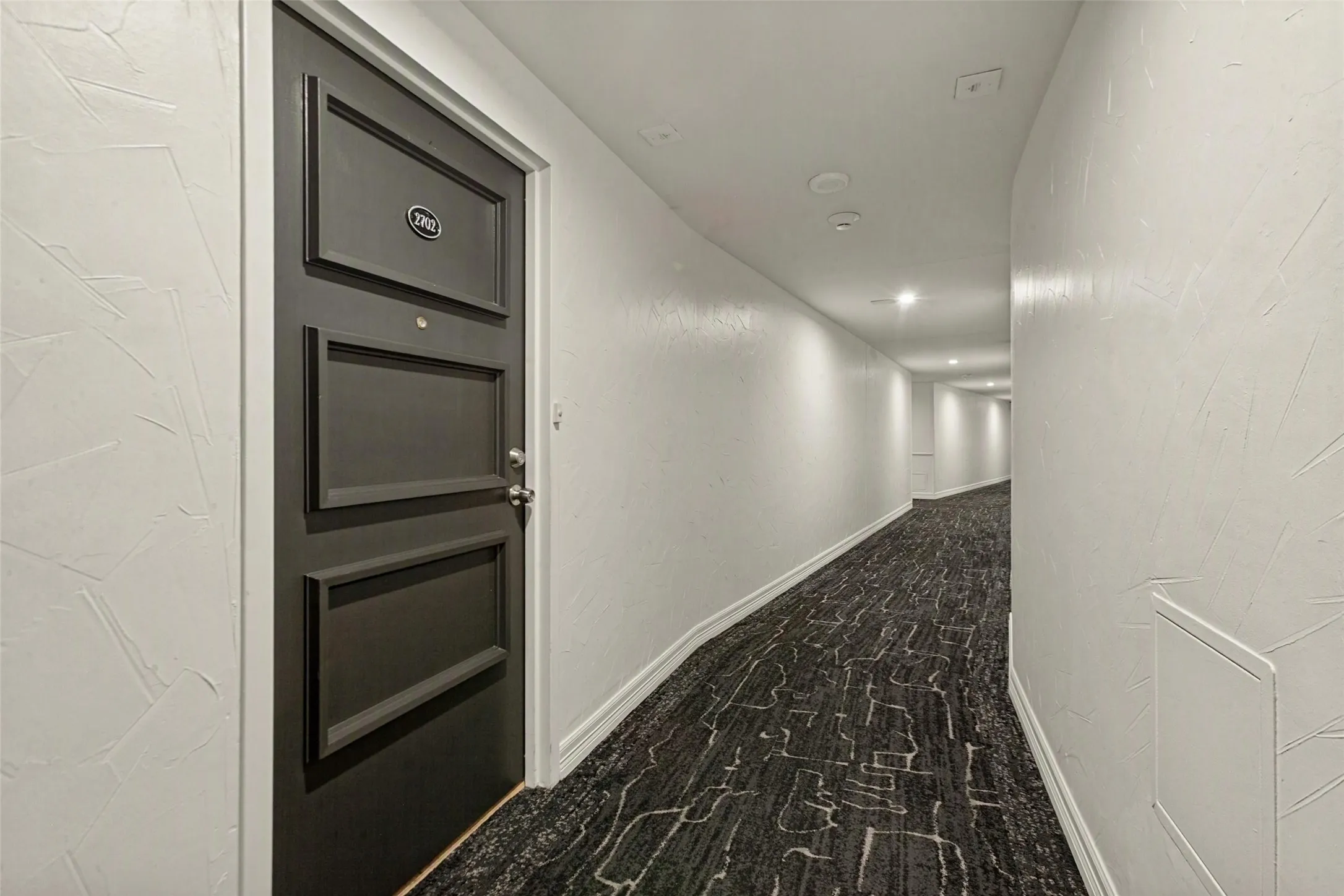 Front door of unit 2702 as seen in main hallway