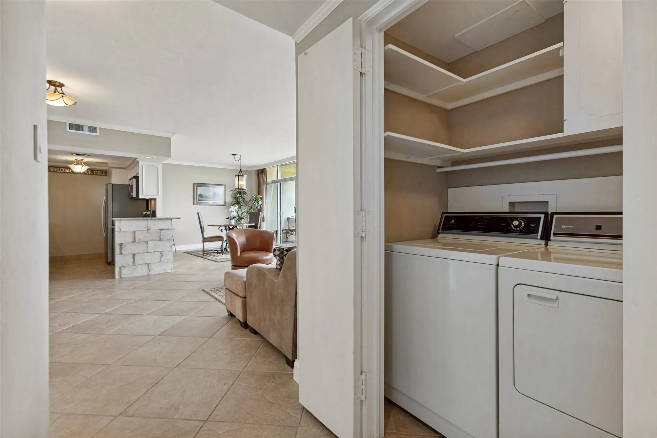 Full size washer-dryer in hallway utility closet