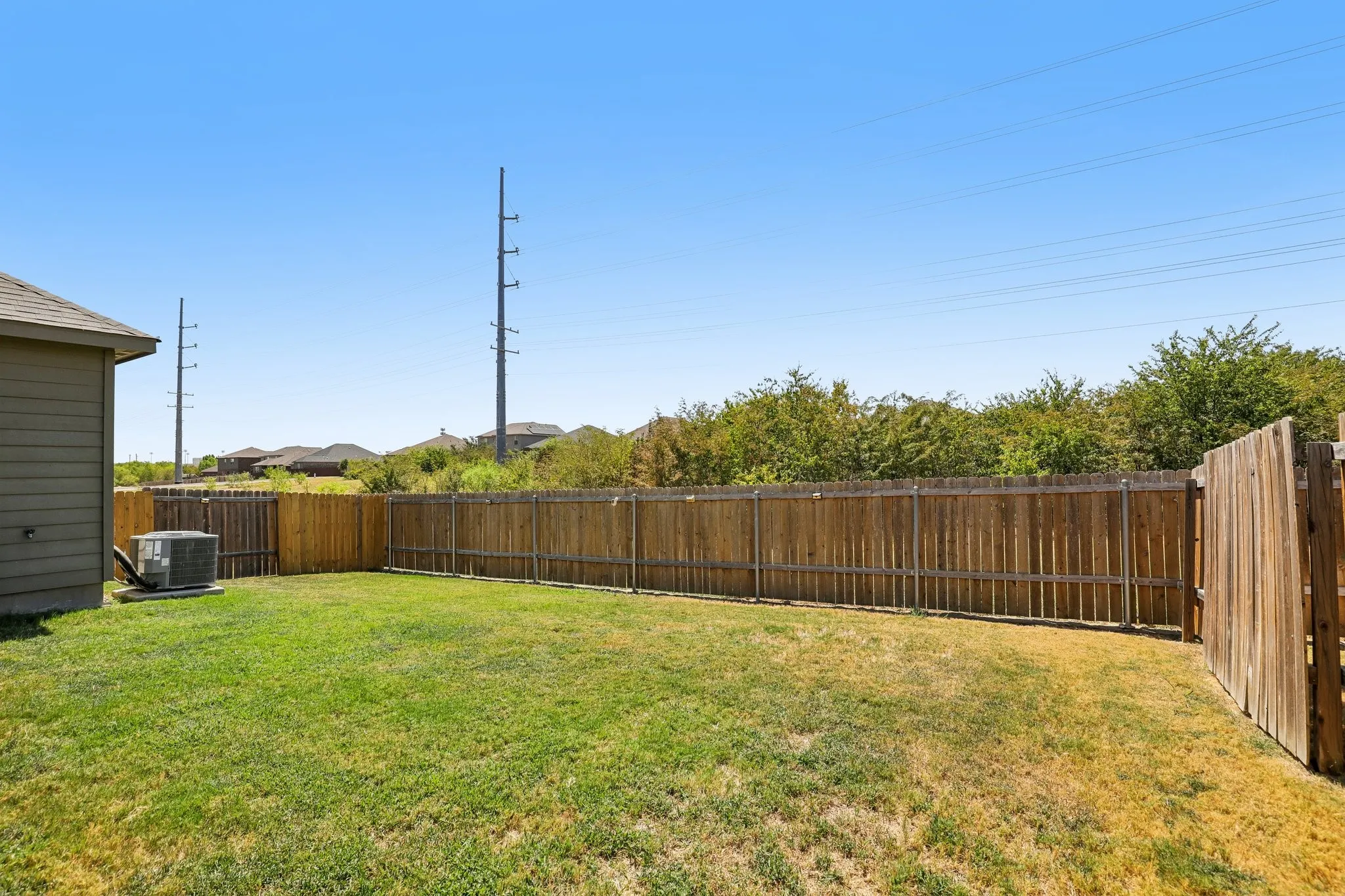 Expansive lawn area with wood privacy fencing