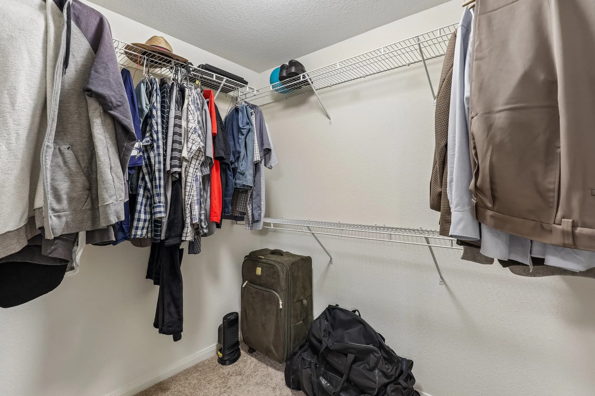Walk-in closet with wire shelving and hanging rods