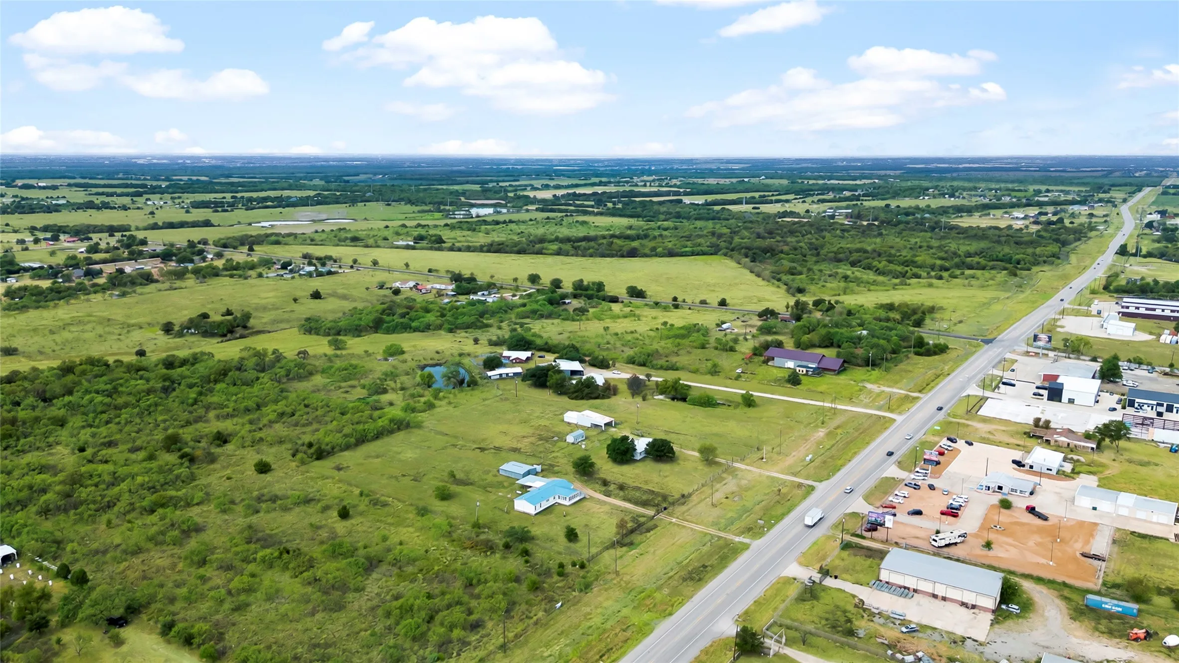 Expansive undeveloped land with scattered mature trees and open clearings