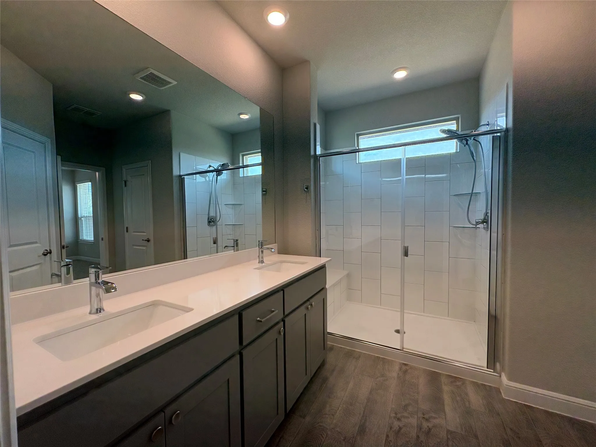 Primary Bath with dual sinks and tile shower