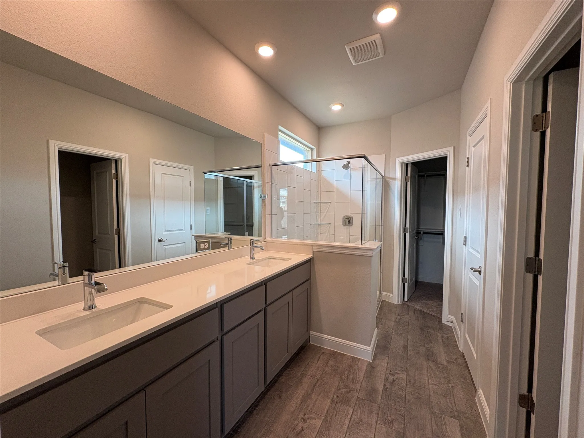 Primary Bathroom with dual sinks and stand up shower