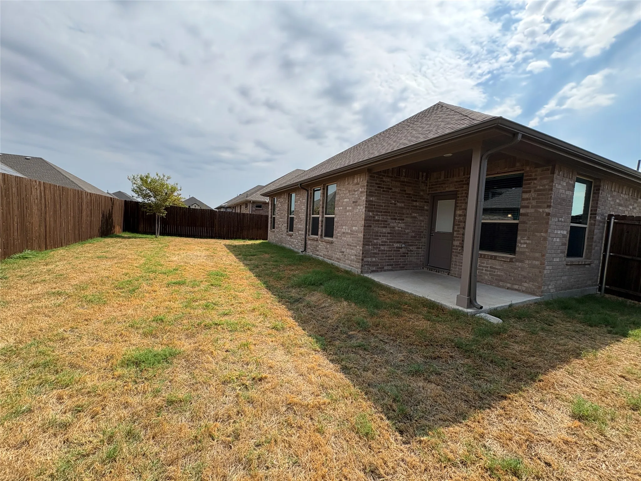 Back yard with covered patio and fenced