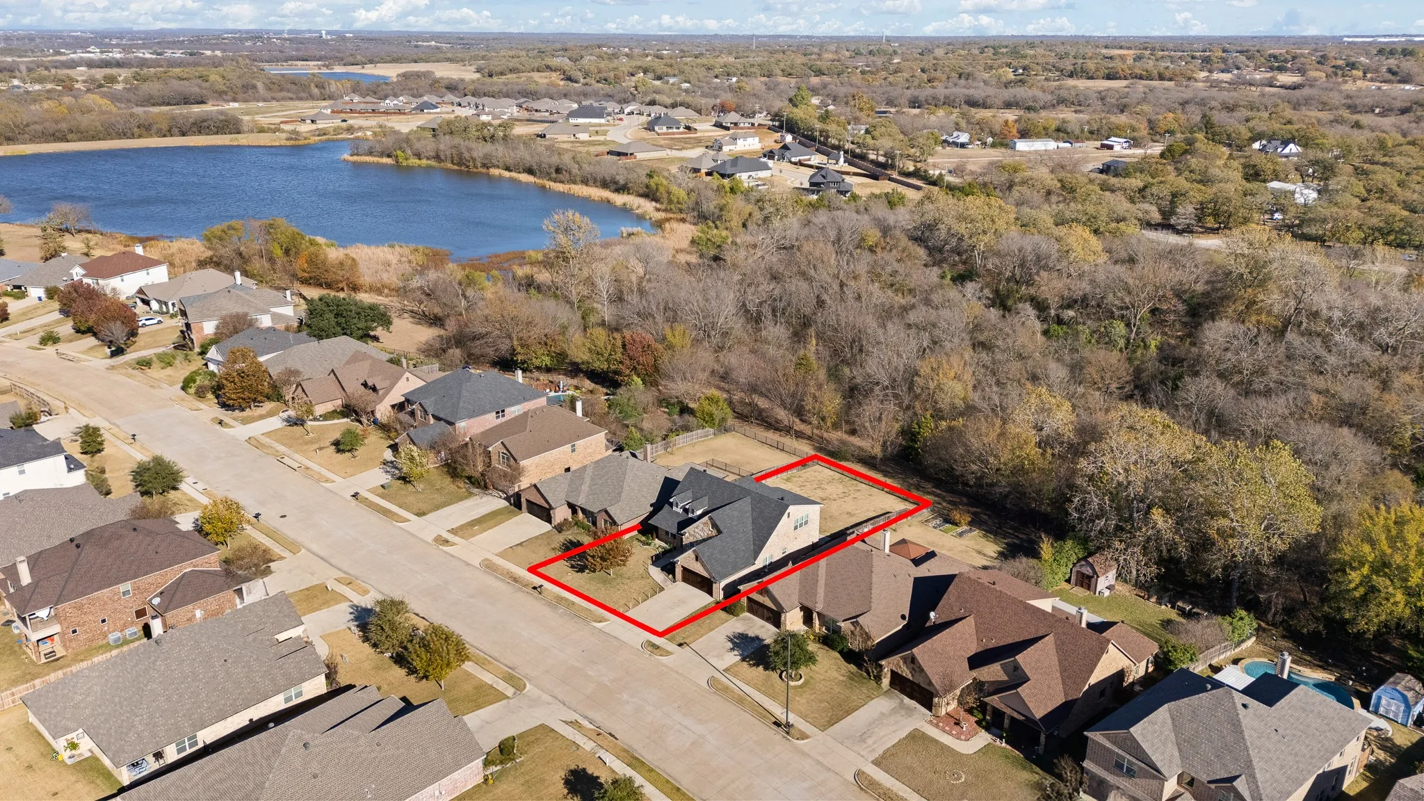 Aerial view showcasing a residential area with a prominent body of water