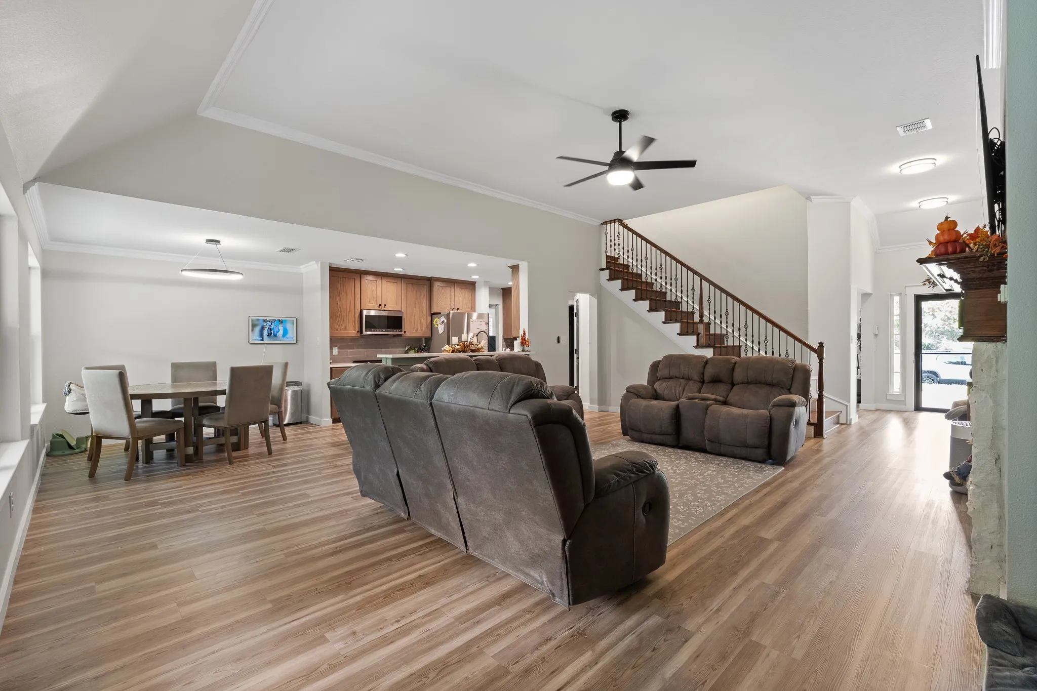 Wood-finish flooring, recessed lighting, and a contemporary ceiling fan