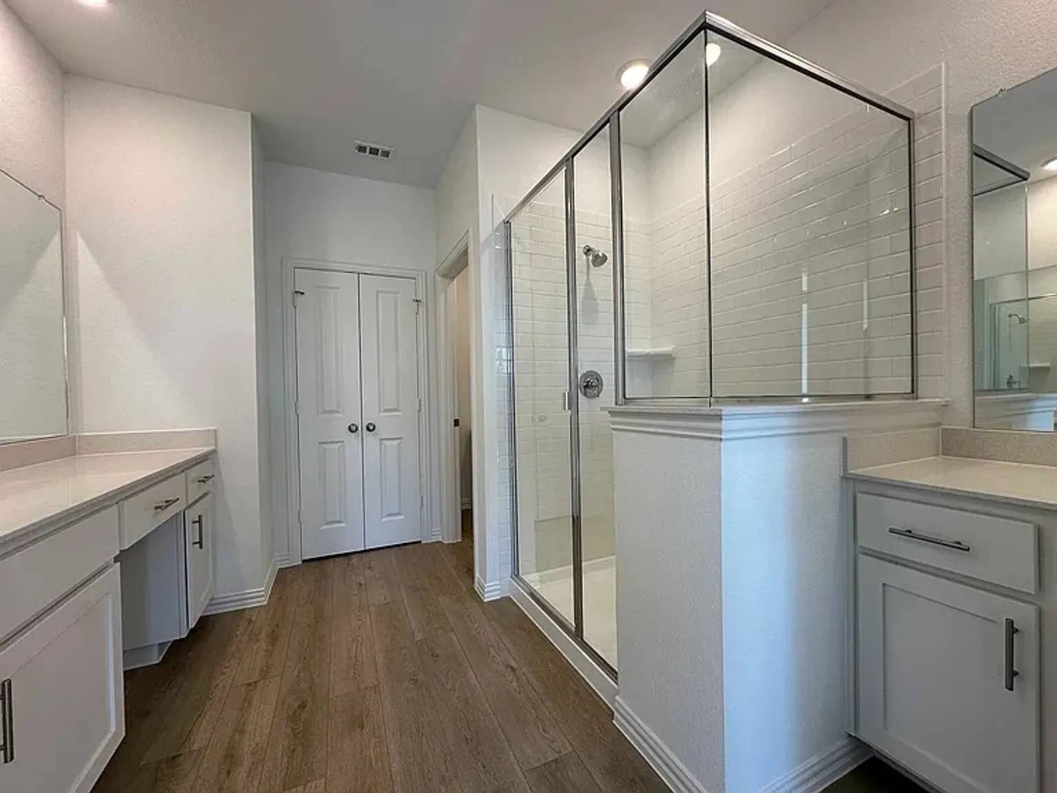 Glass-enclosed shower with subway tile surround