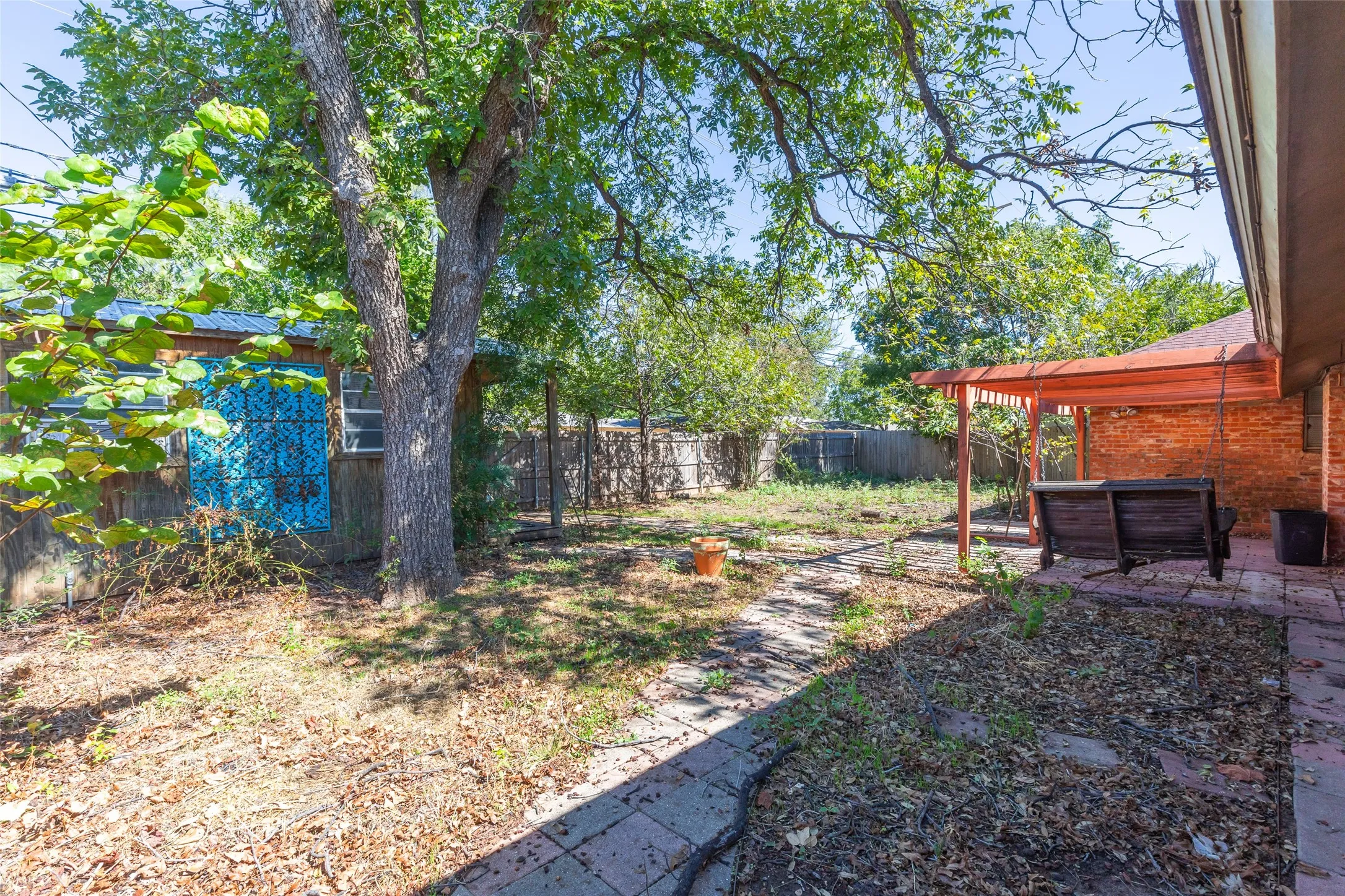 Brick patio with an overhead pergola structure