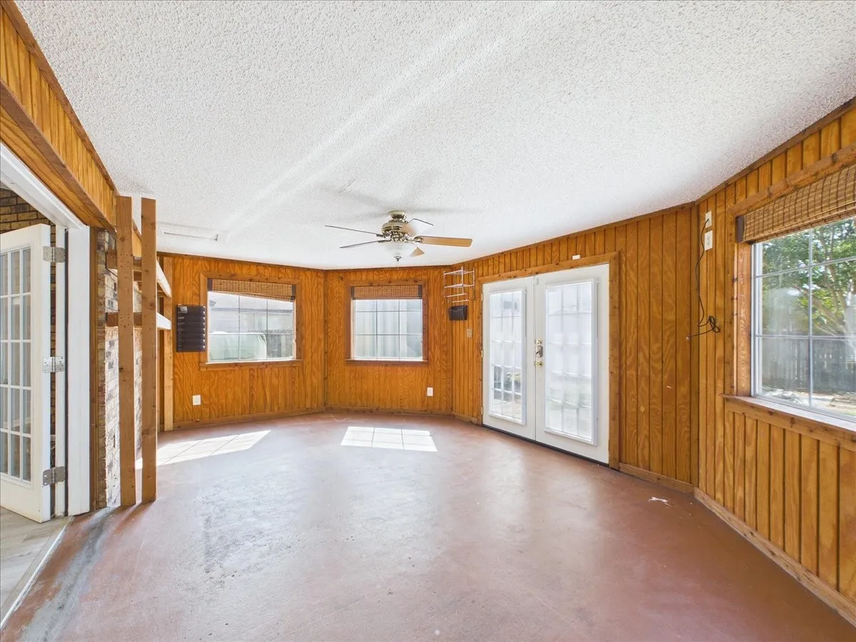 Back room with central air and exit to the backyard.